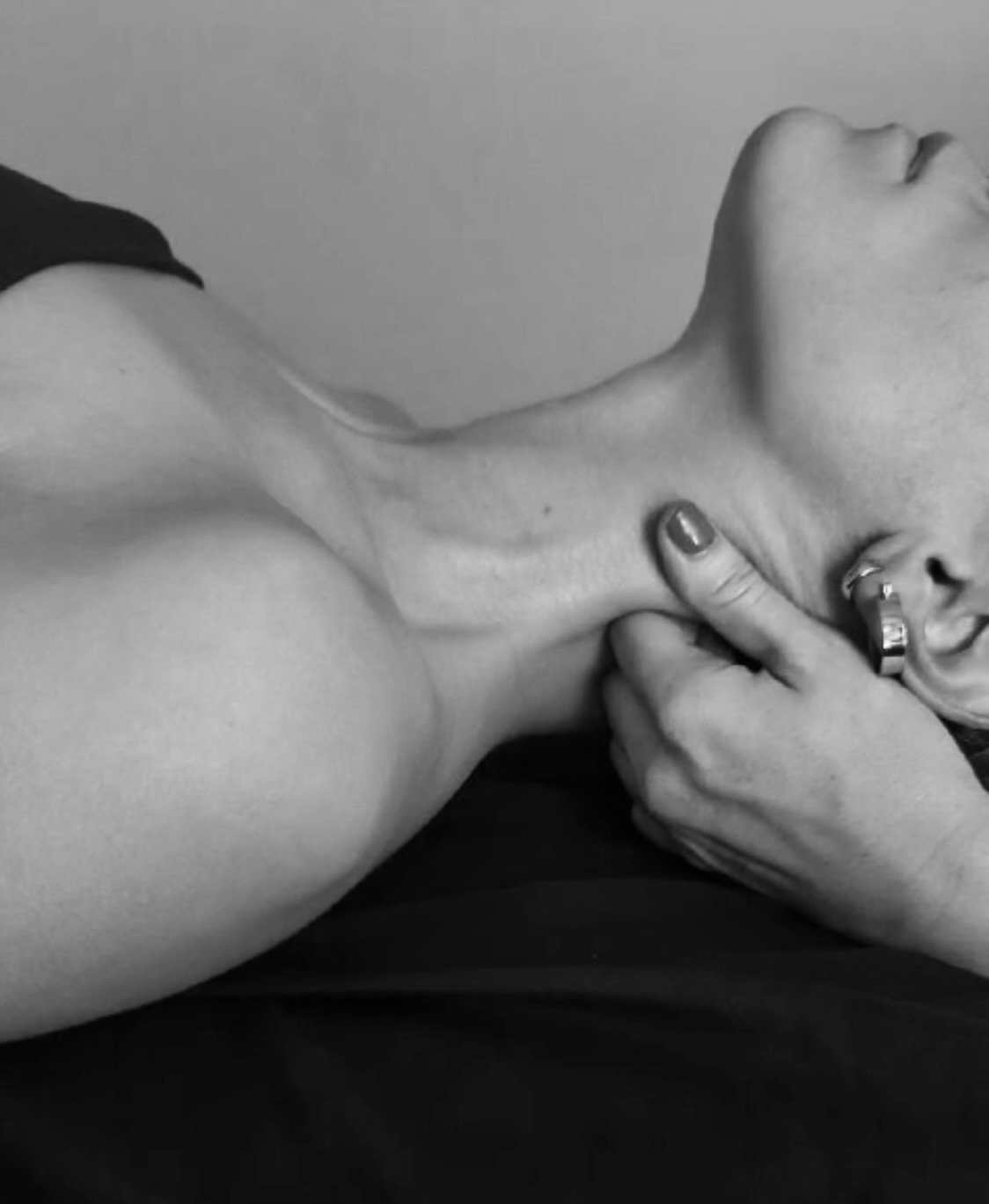 a woman on her back getting a deep neck massage