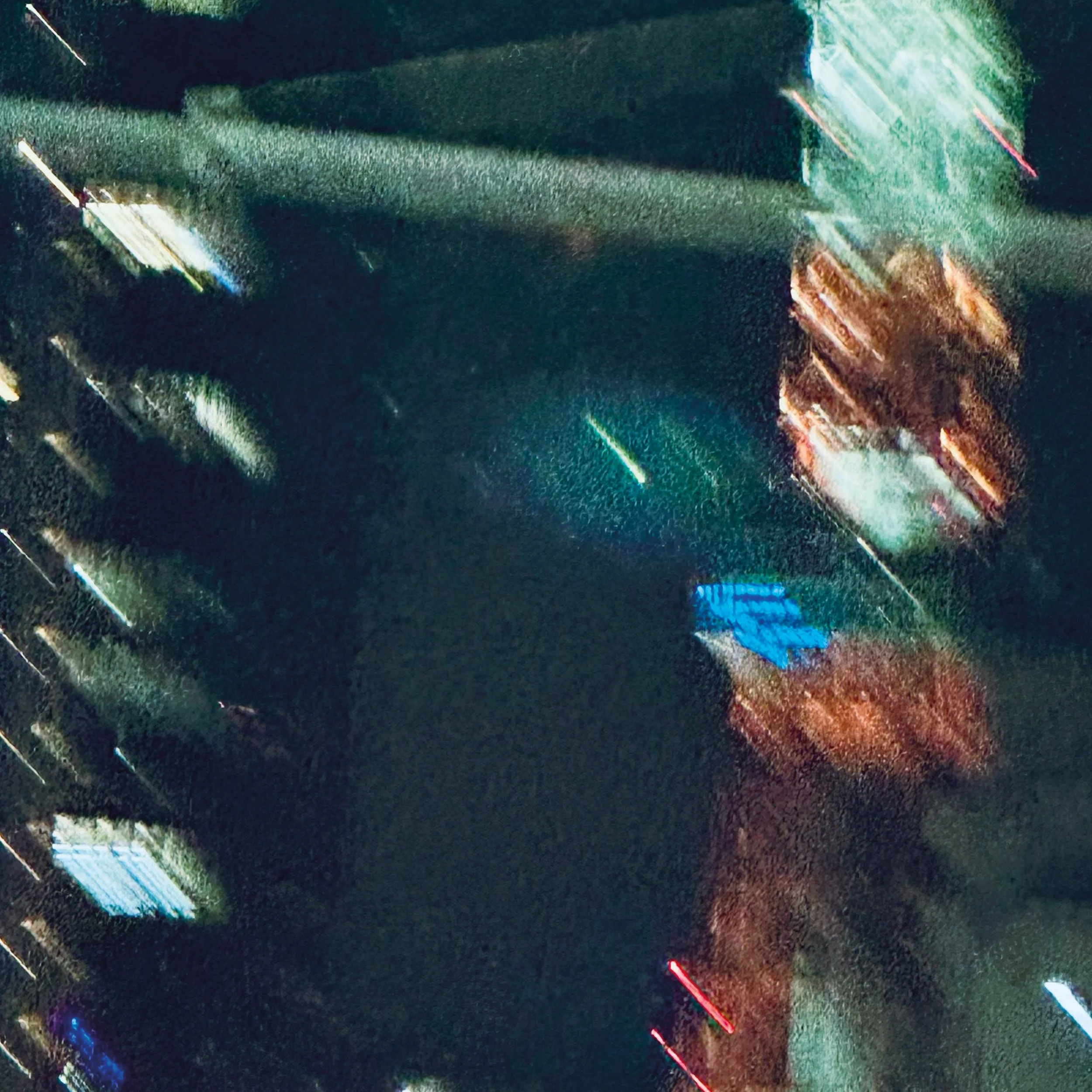 Nighttime scene with illuminated laser light beams crossing the dark sky, creating a colorful light display.