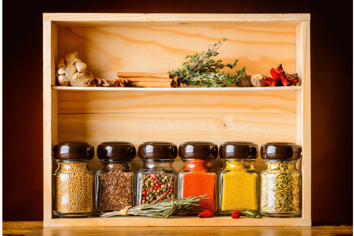 Organized spice cabinet with jars of spices and dried herbs