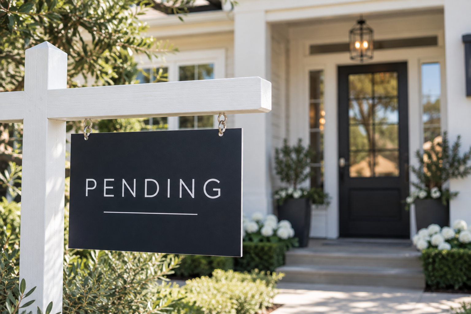 Pending real estate sign in front of a bright, well-maintained home, representing a home under contract and moving through escrow toward closing.