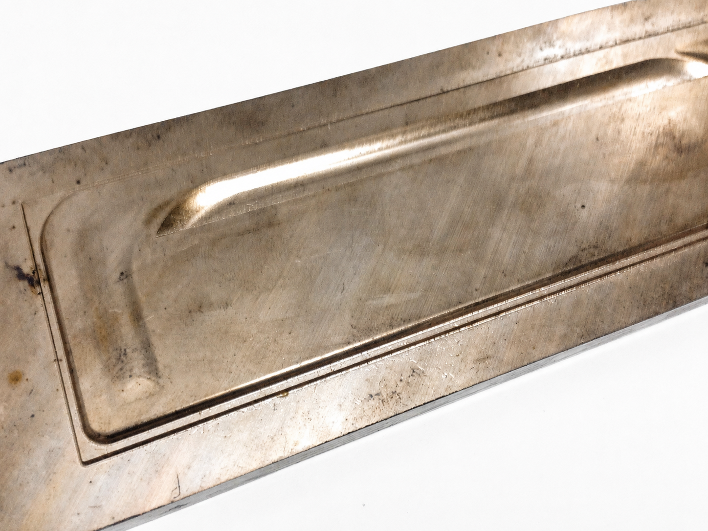 Original Bixby comb moulding plate used to heat-form acetate during the manufacturing process.