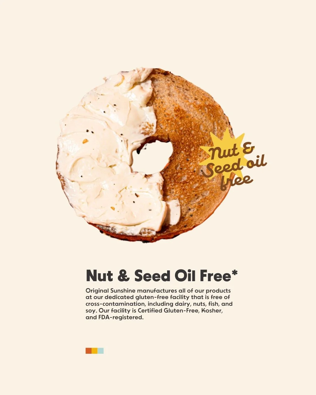 A gluten-free bagel with cream cheese, topped with crushed nuts and black pepper, and a label indicating it is nut and seed oil free.