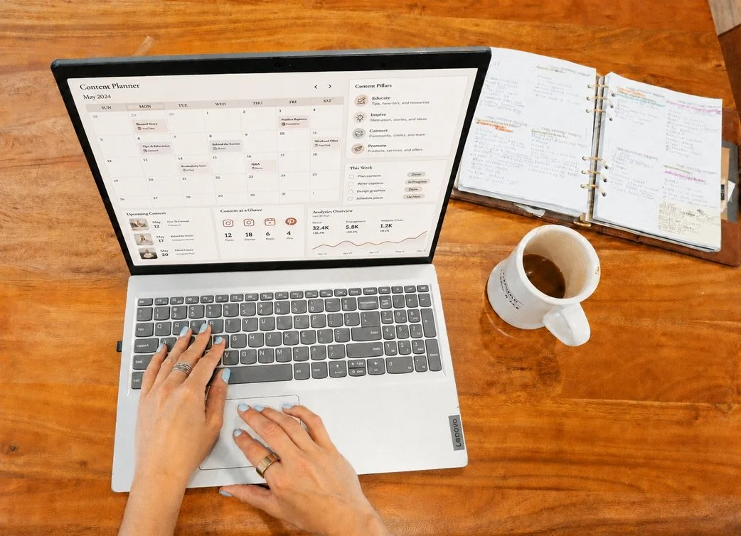 Content planning workspace with digital calendar, handwritten notes and coffee on a wooden desk.