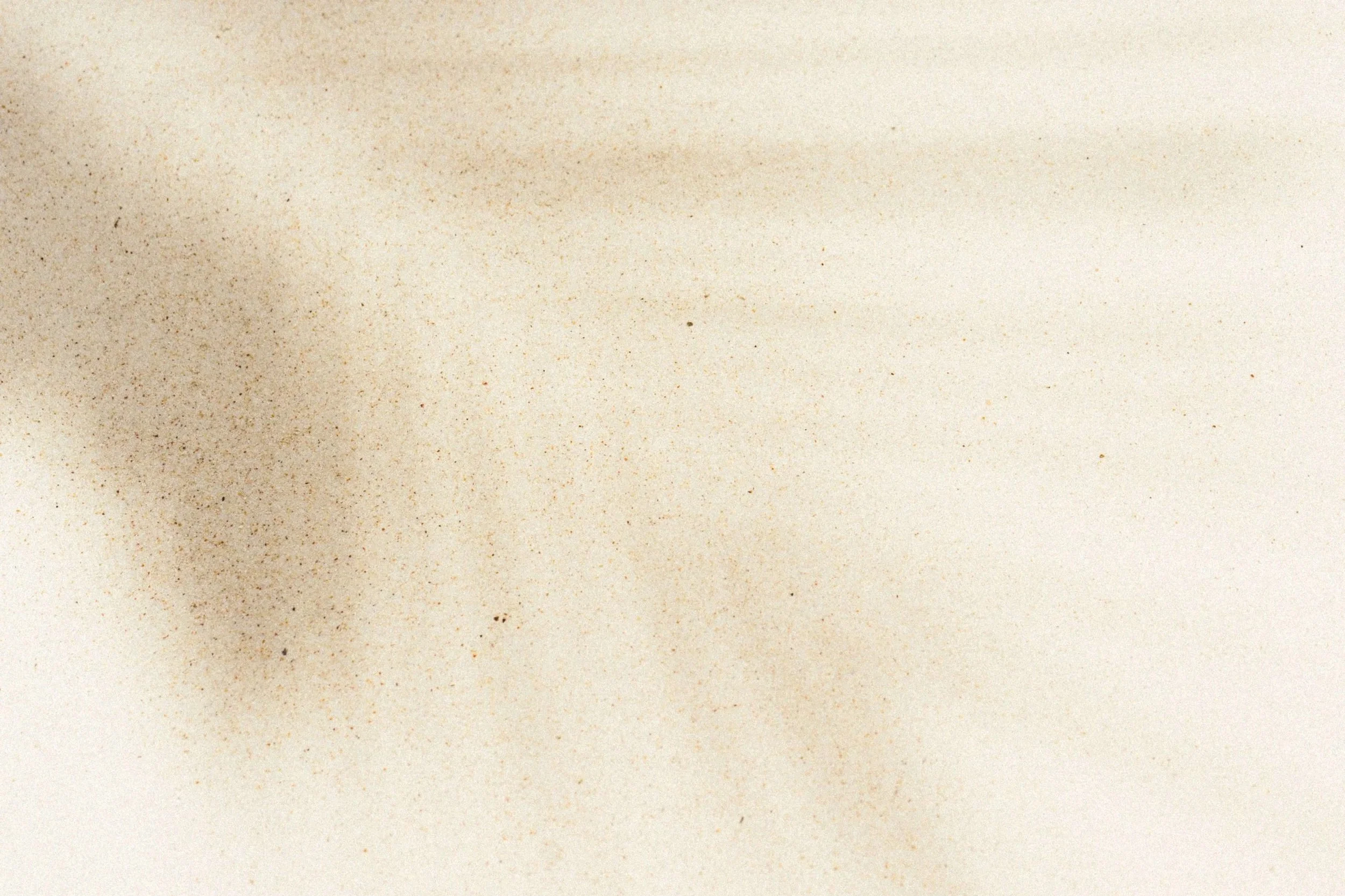 A blank, off-white textured paper with a subtle speckled pattern.