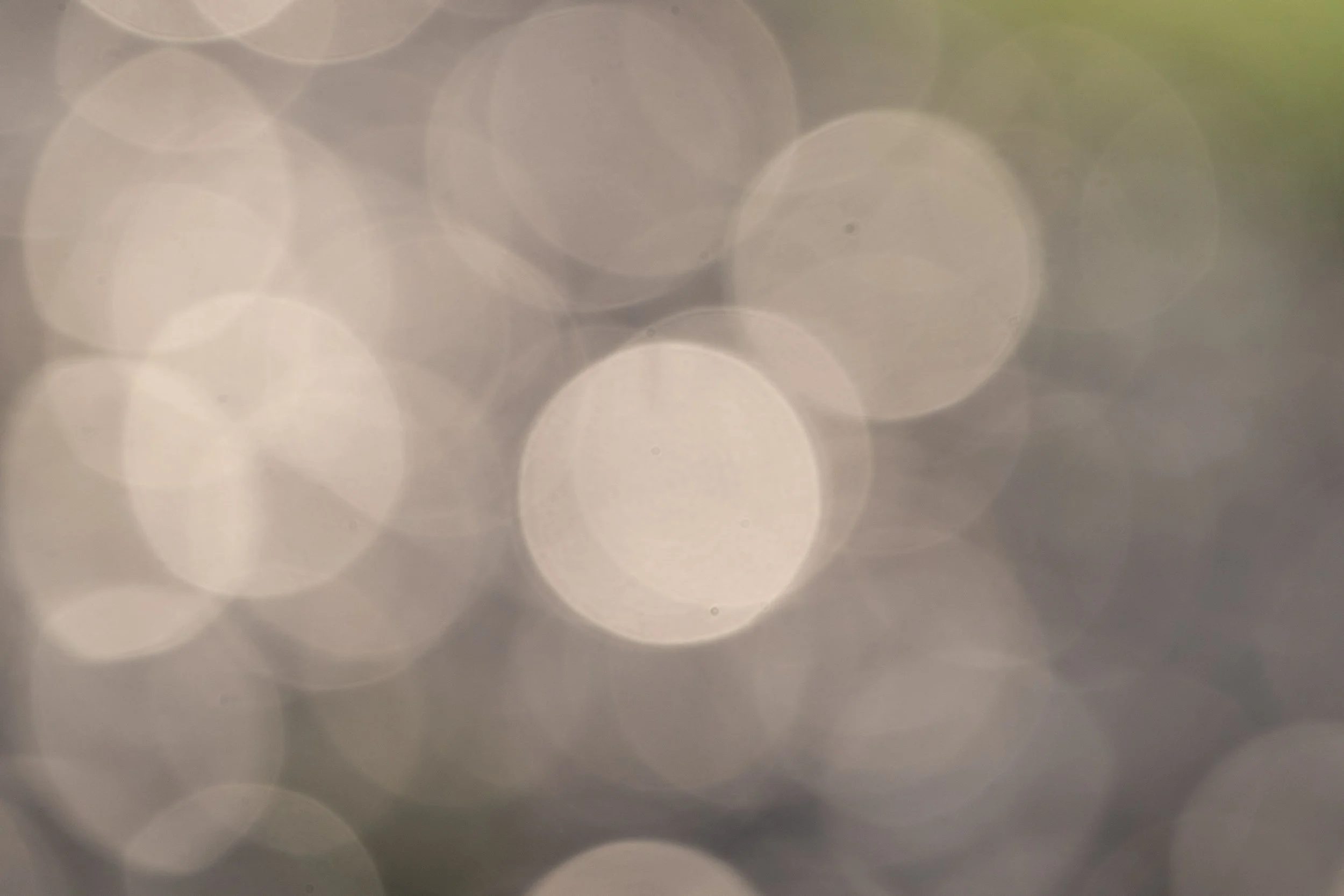 Blurred image with circular light spots, likely out-of-focus lights or reflections.