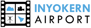 Logo of INYOKERN Airport with text and icons representing map, airplane, wind turbines, and town outline.