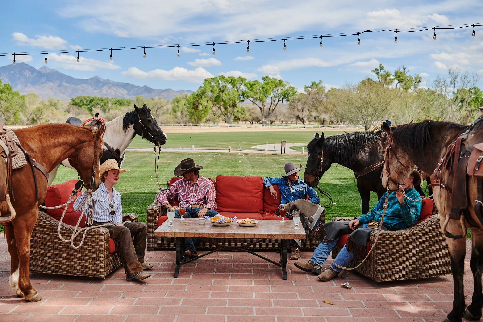 Dude ranch guests enjoy cocktail hour at the Otero Ranch during a dude ranch vacation.