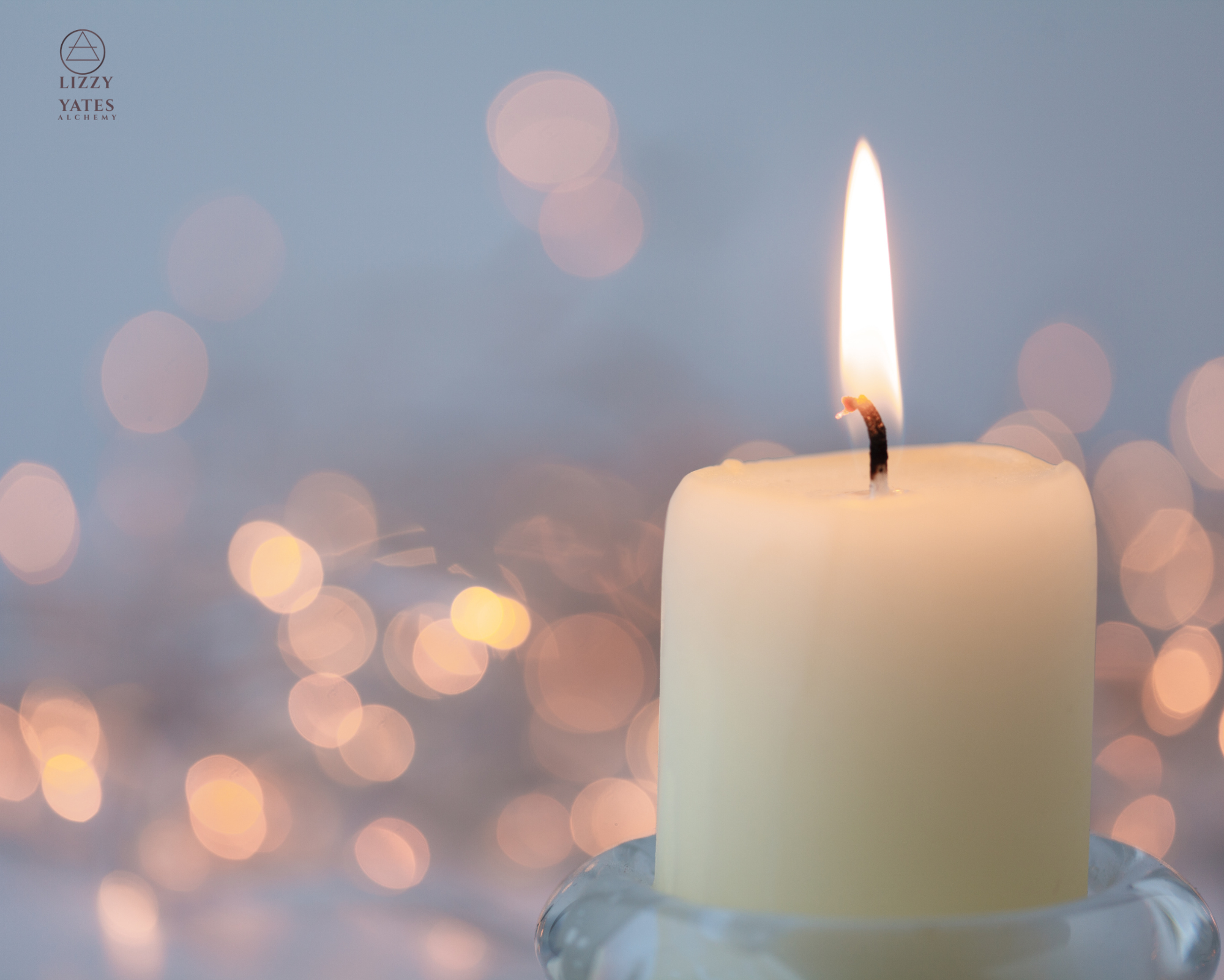 Close-up of a lit white candle with a blurred background of warm bokeh lights.