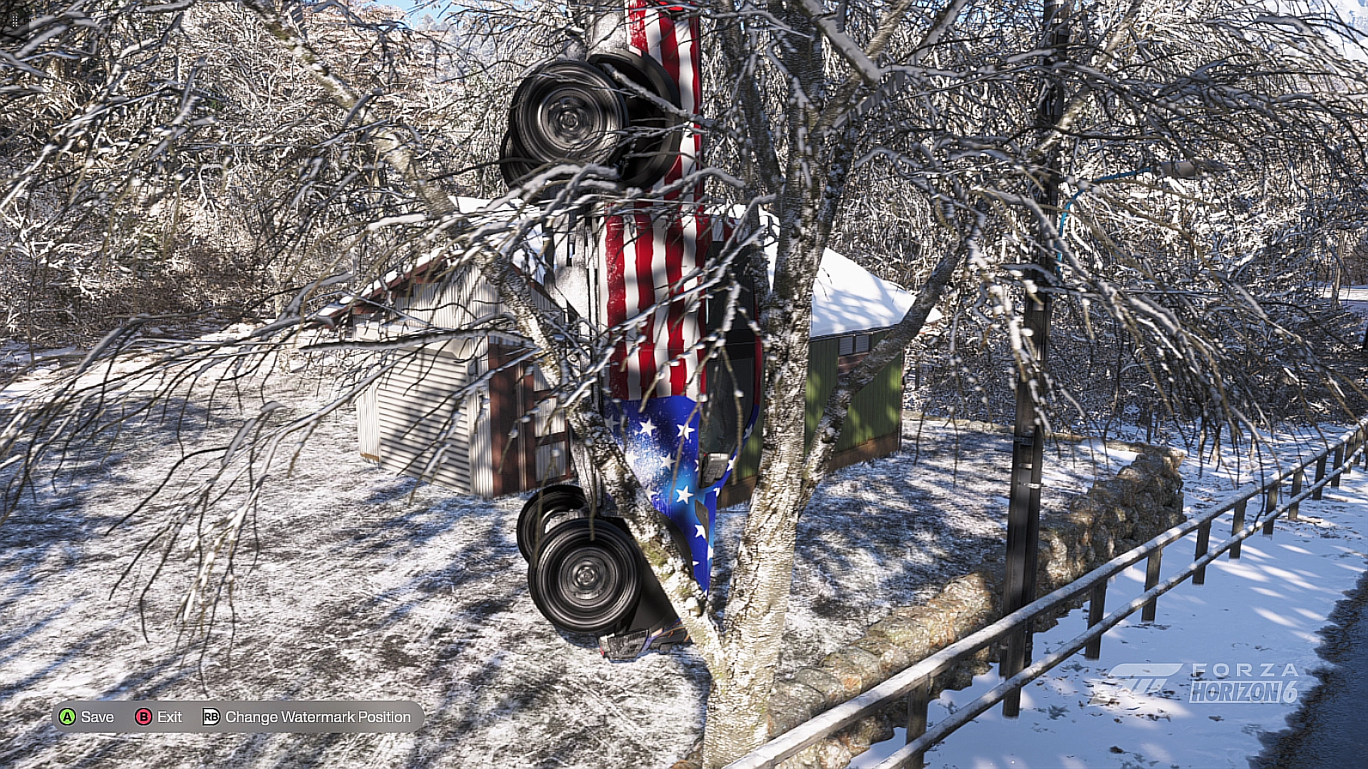 A tree with snow-covered branches leaning against a building with an American flag decal. A black speaker is mounted on the tree, and the scene is snowy and wintry.