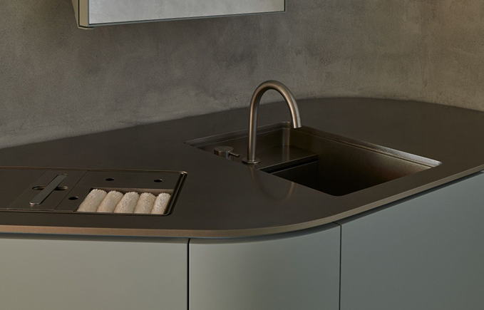 Kitchen sink with a modern gray countertop and a small dish drying area with a wire rack.
