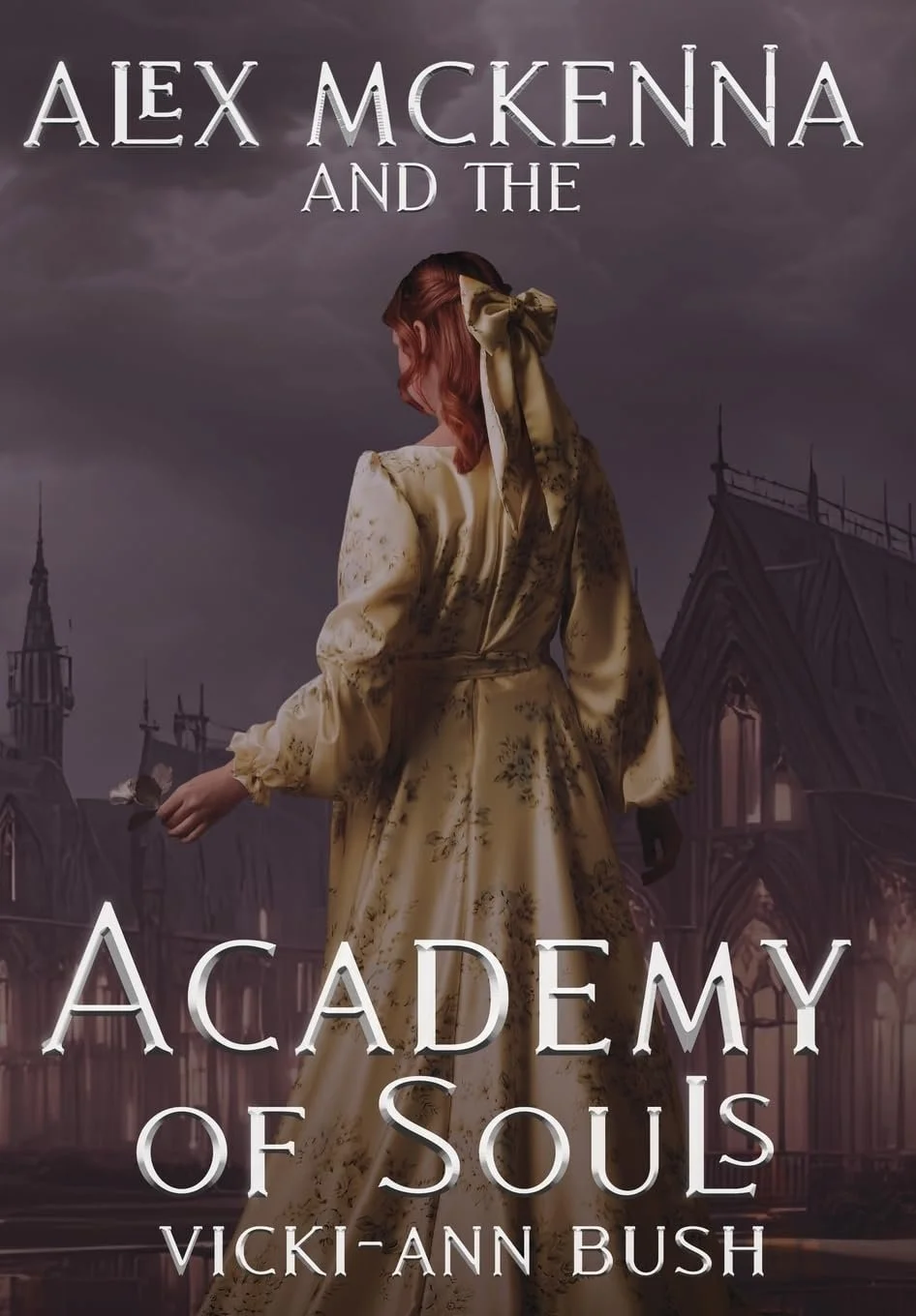 Book cover for 'Academy of Souls' by Vicki-Ann Bush featuring a woman with red hair in a gold patterned dress with a bow in her hair, holding a black flower, standing in front of a gothic cityscape with dark, cloudy skies.
