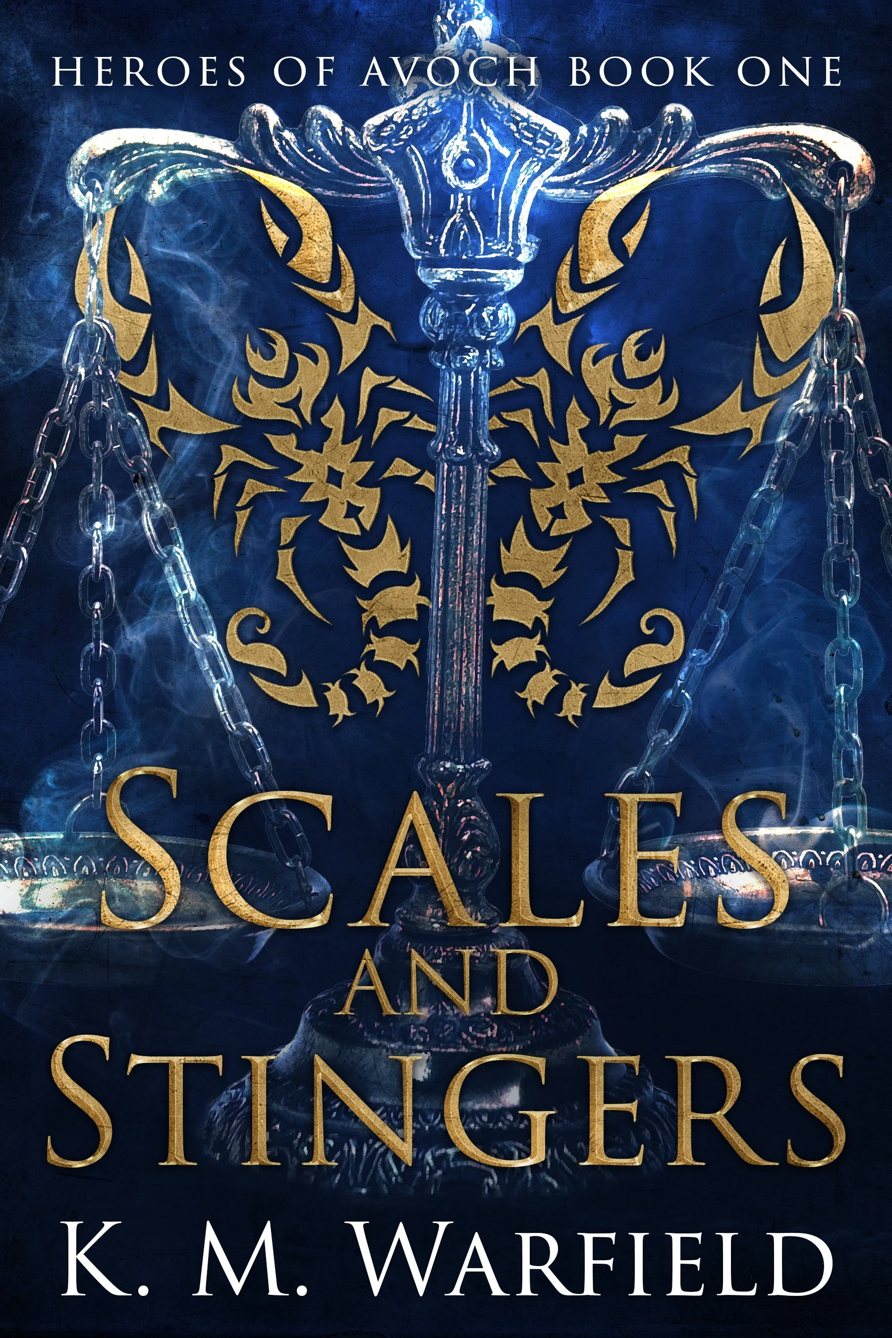Book cover titled "Heroes of Avoch Book One" with a dark blue background. Features a golden emblem of a sword with intricate designs and chains hanging from it, and a stylized lion's head in the background. The author's name, "K. M. Warfield," is at the bottom.