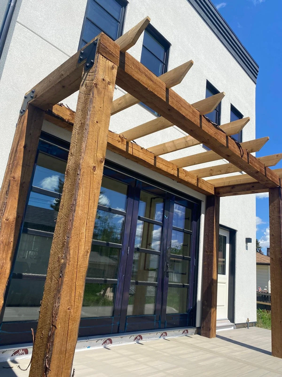 Wooden framing for a custom patio or deck installation, carefully constructed to provide a strong foundation for a beautiful and functional outdoor entertainment area.