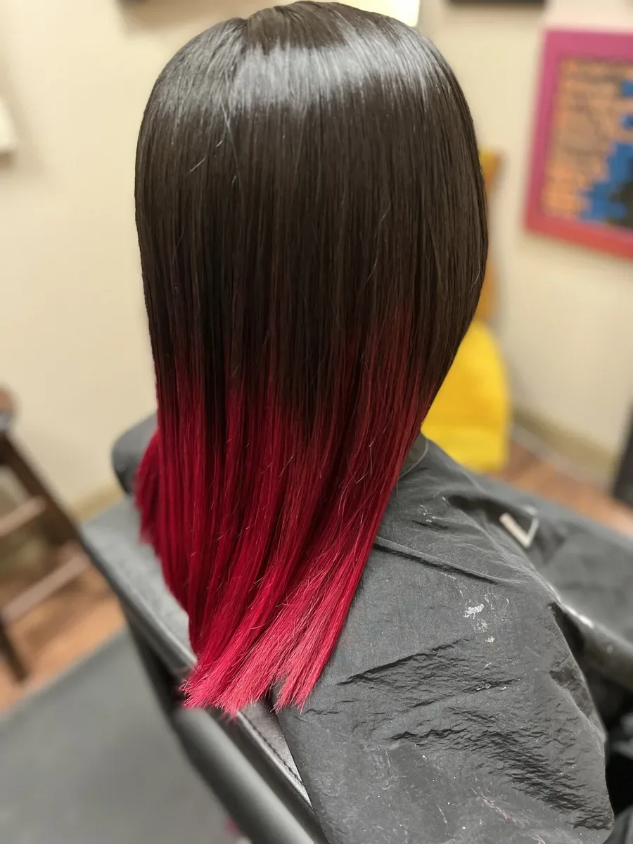 Dark hair with red fashion color ends by The Hair Court in Bryan-College Station, TX.