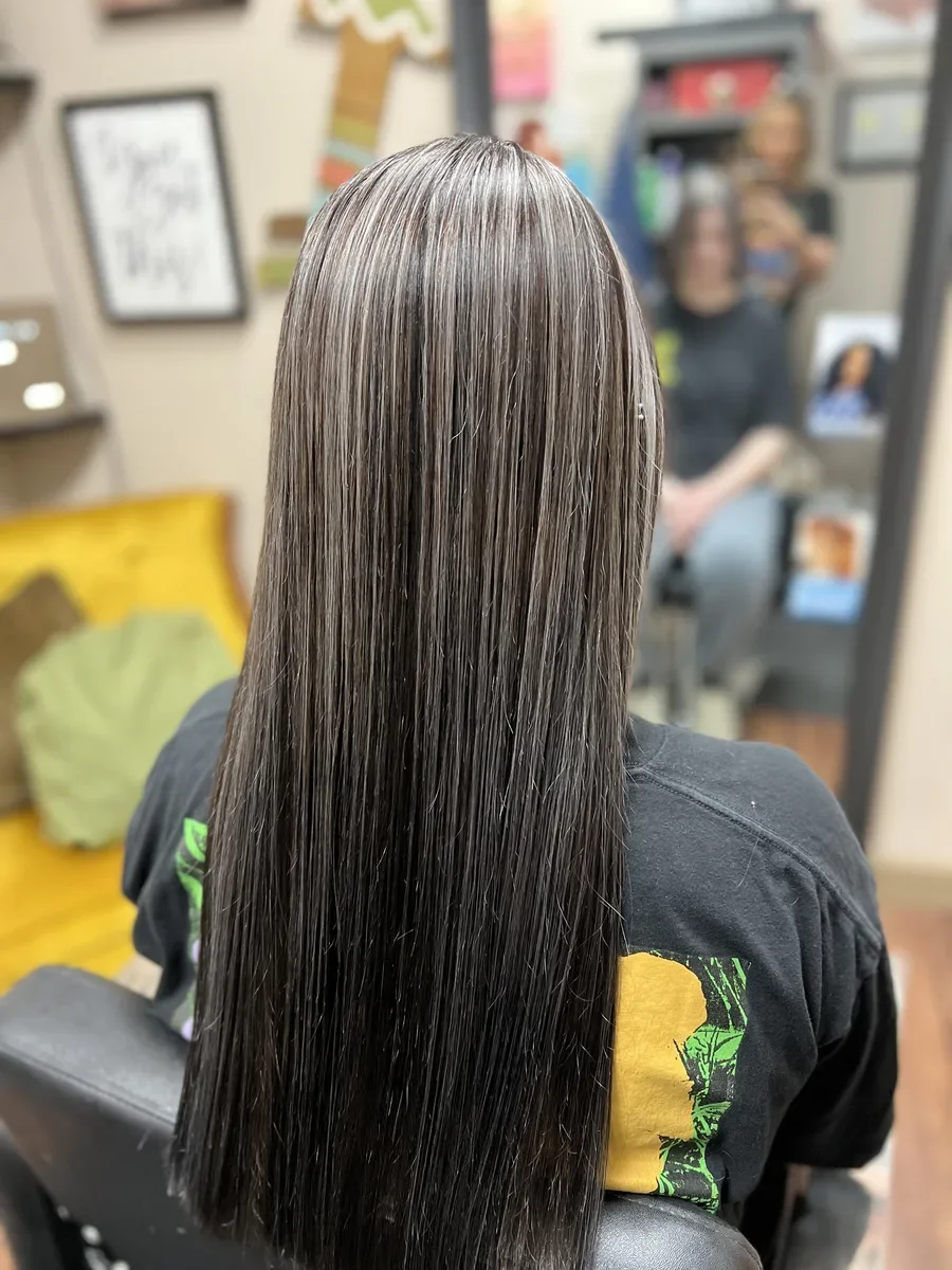 Long glossy dark hair by The Hair Court in Bryan-College Station, TX.