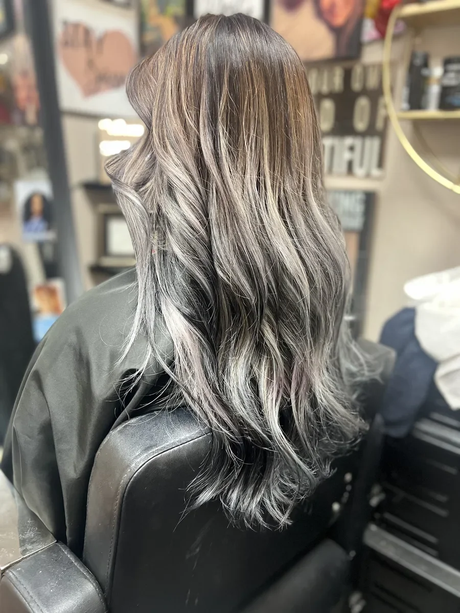 Silver blonde wavy hair by The Hair Court in Bryan-College Station, TX.