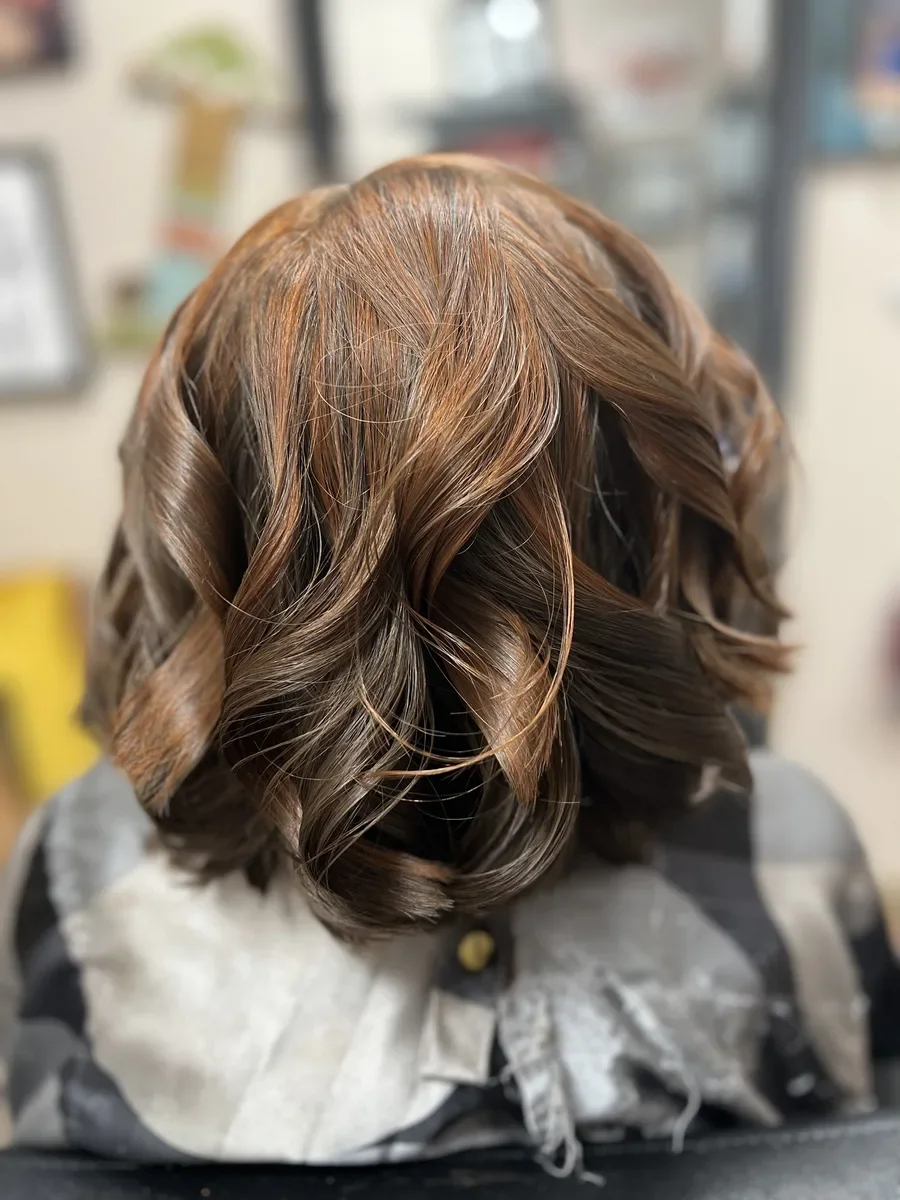 Short brunette curled bob by The Hair Court in Bryan-College Station, TX.