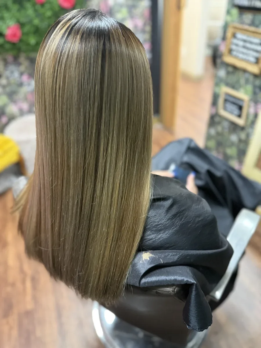Long ash blonde straight hair by The Hair Court in Bryan-College Station, TX.