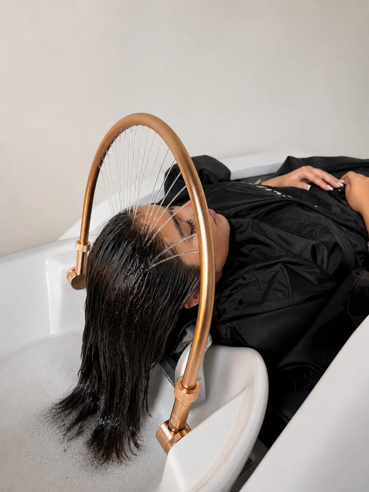 Luxury head spa treatment featuring a soothing water halo, scalp therapy, and relaxation at The Hair Court Salon & Extension Boutique in Bryan–College Station, Texas.