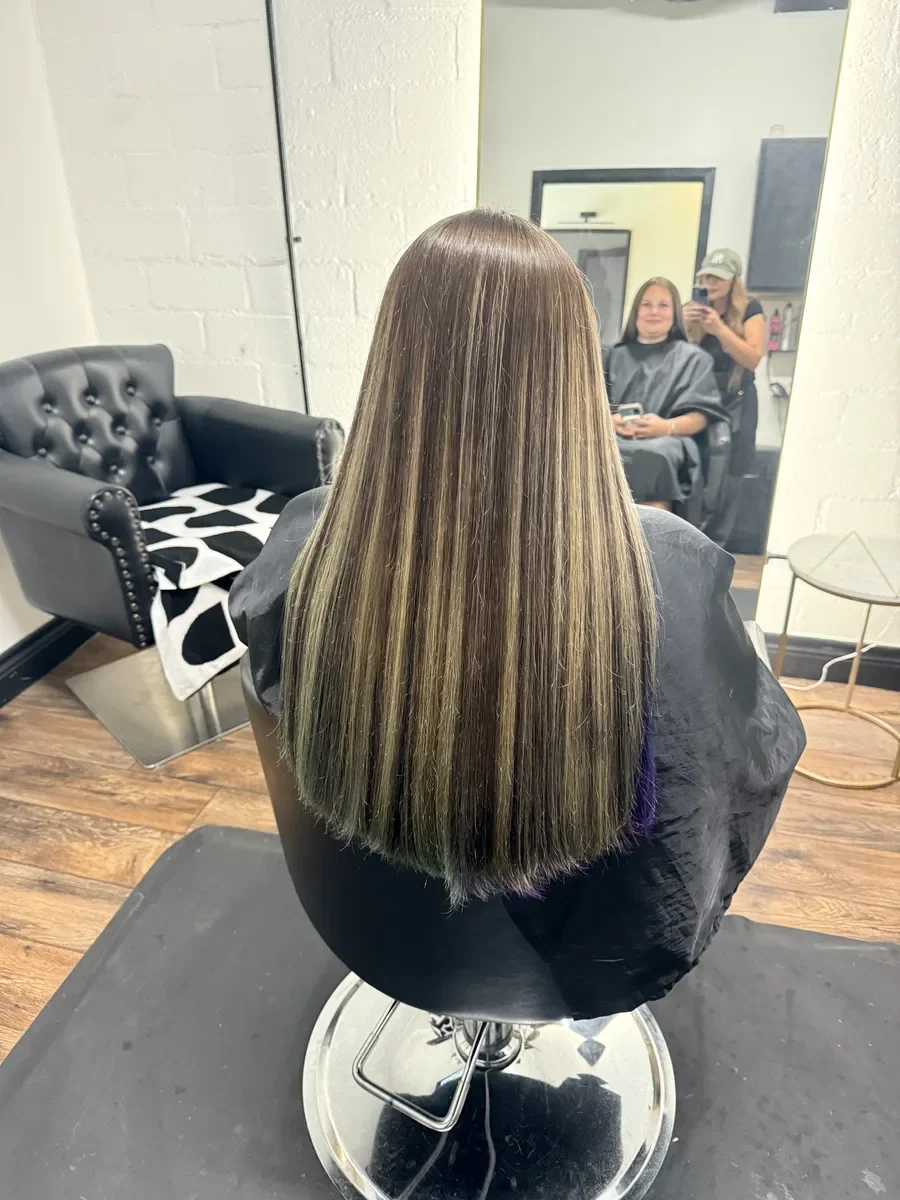Long dimensional bronde straight hair by The Hair Court in Bryan-College Station, TX.