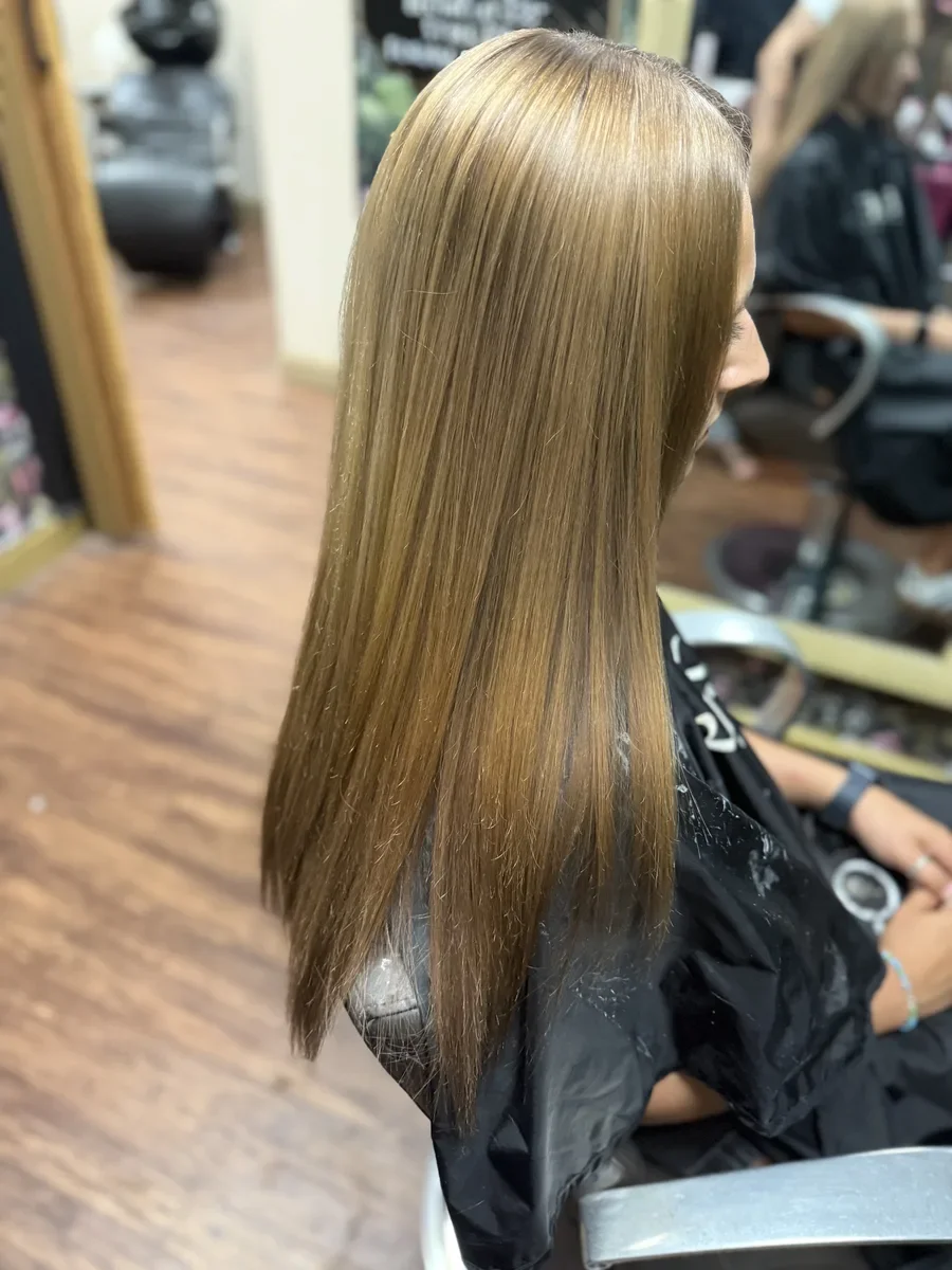Long blonde straight hair by The Hair Court in Bryan-College Station, TX.