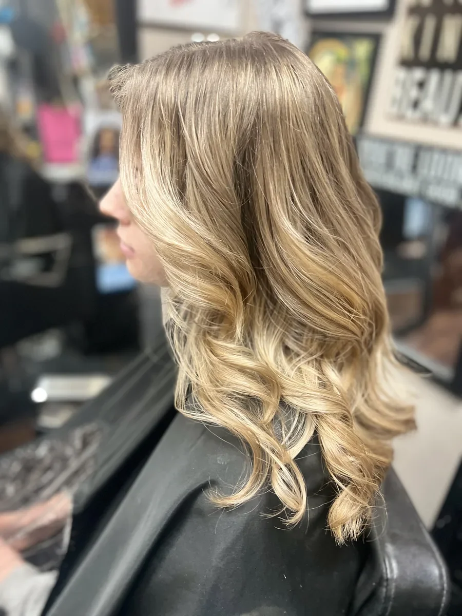 Long blonde soft waves by The Hair Court in Bryan-College Station, TX.