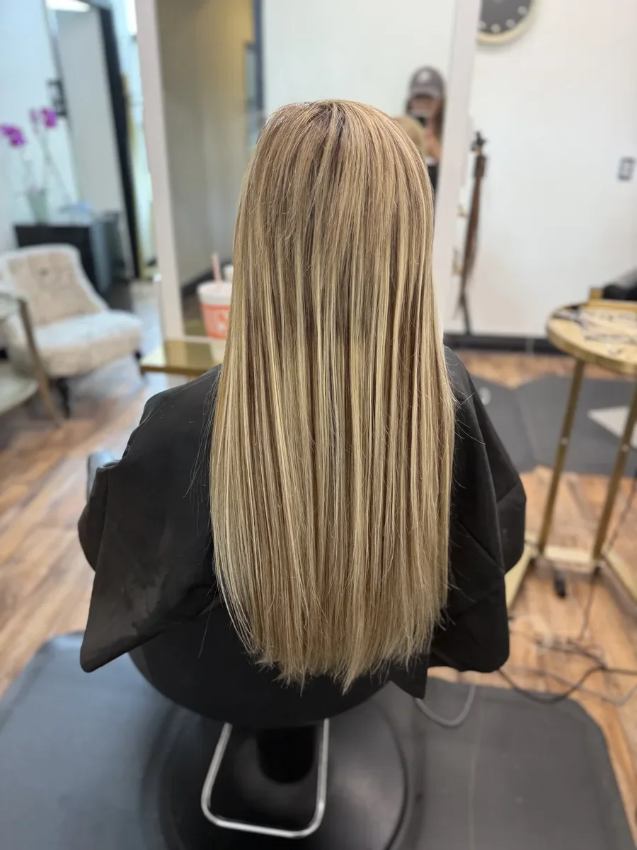 Long straight blonde hair by The Hair Court in Bryan-College Station, TX.