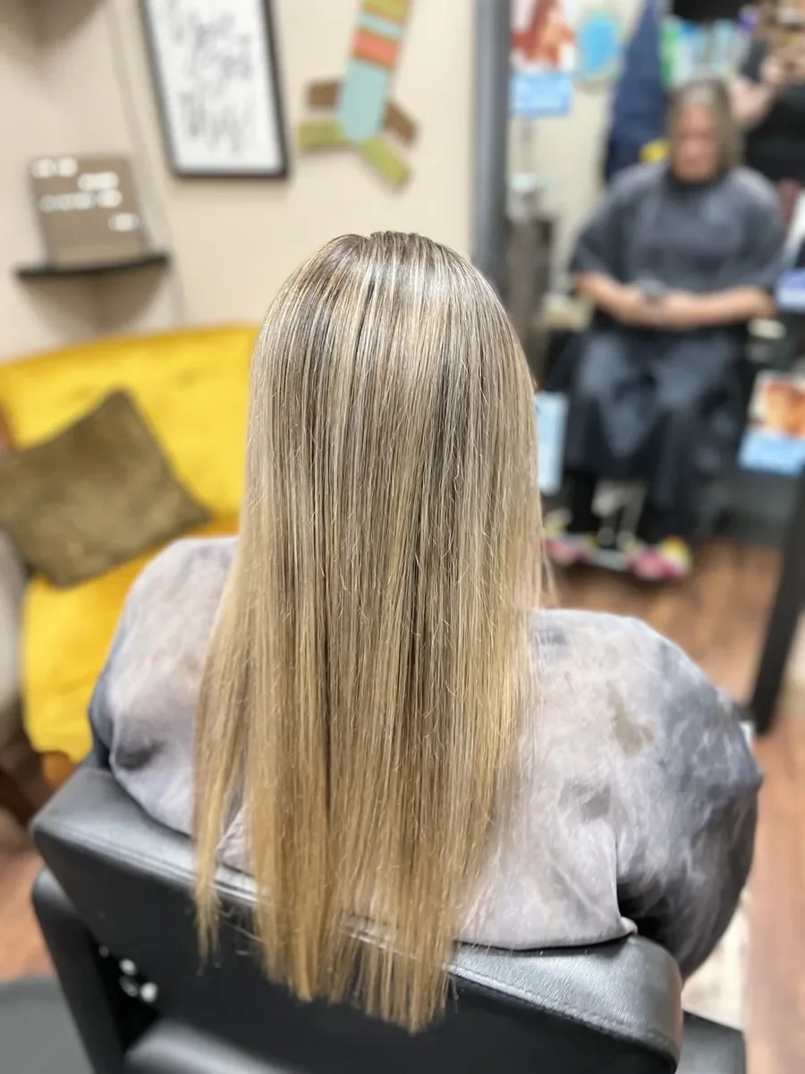 Long dimensional blonde hair by The Hair Court in Bryan-College Station, TX.