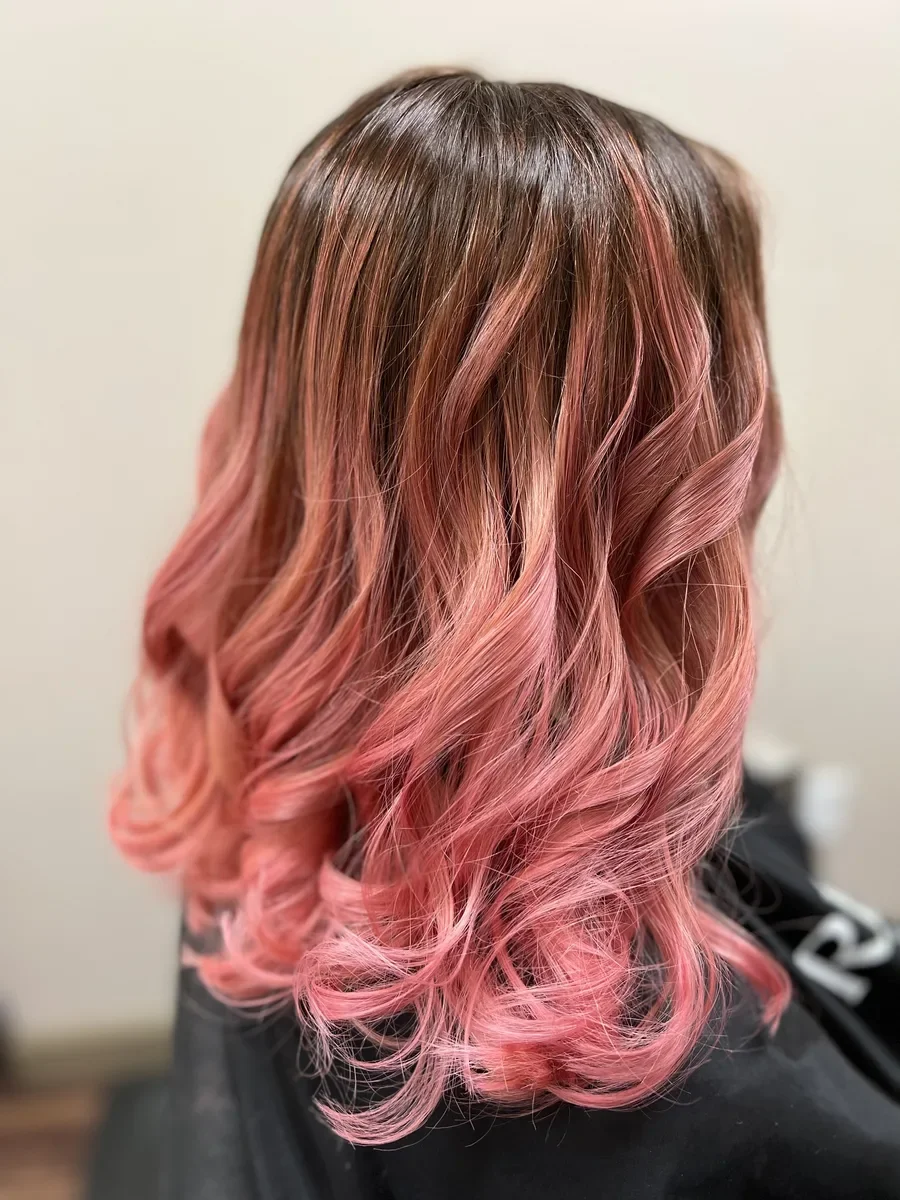Pink fashion color wavy hair by The Hair Court in Bryan-College Station, TX.