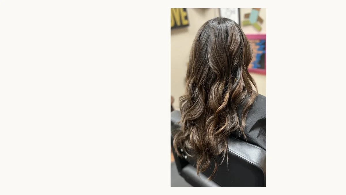 Long brunette wavy hair by The Hair Court in Bryan-College Station, TX.