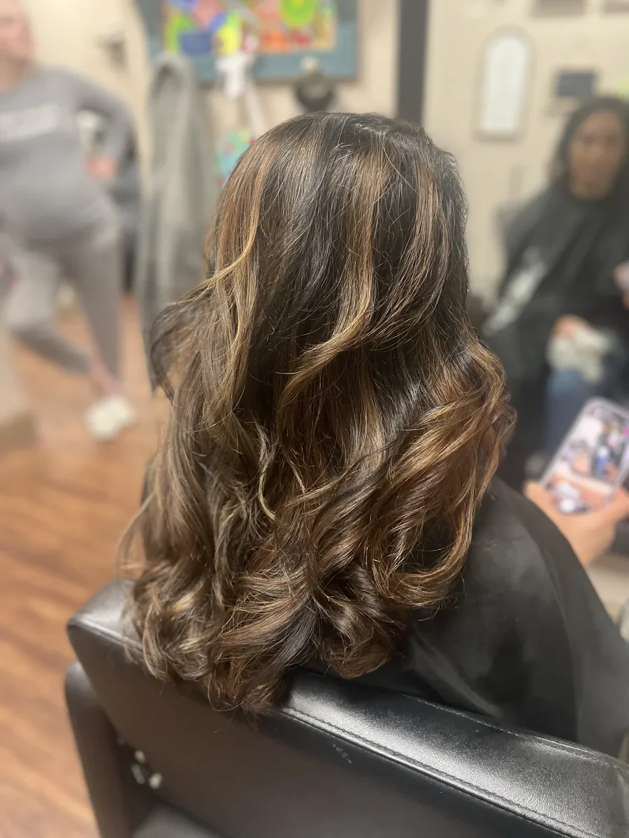 Long brunette soft waves by The Hair Court in Bryan-College Station, TX.