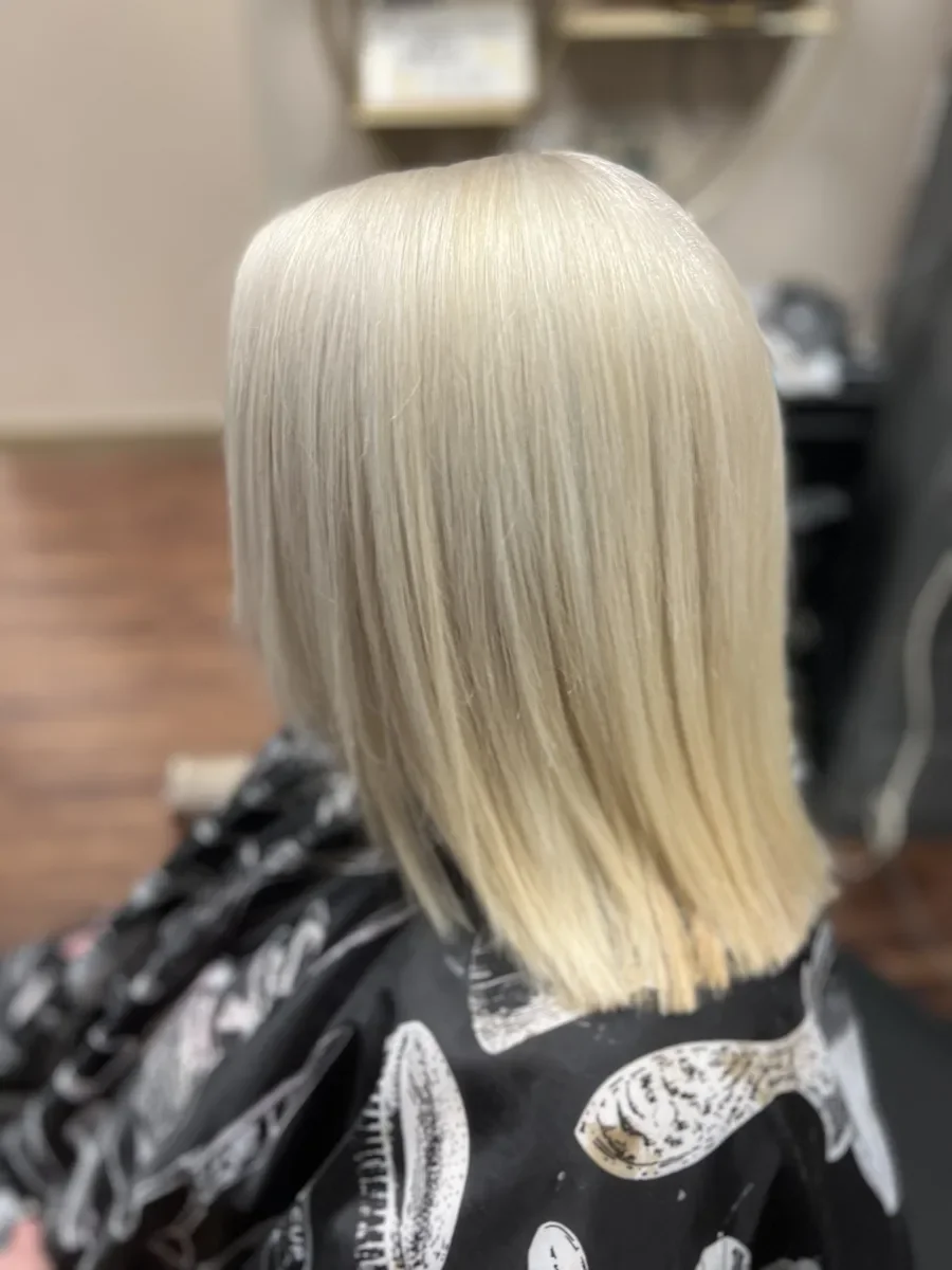Platinum blonde straight hair by The Hair Court in Bryan-College Station, TX.