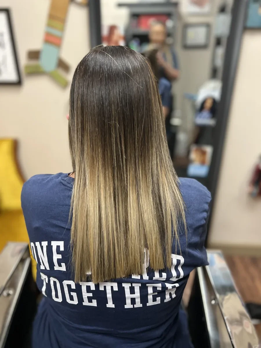 Long rooted blonde straight hair by The Hair Court in Bryan-College Station, TX.