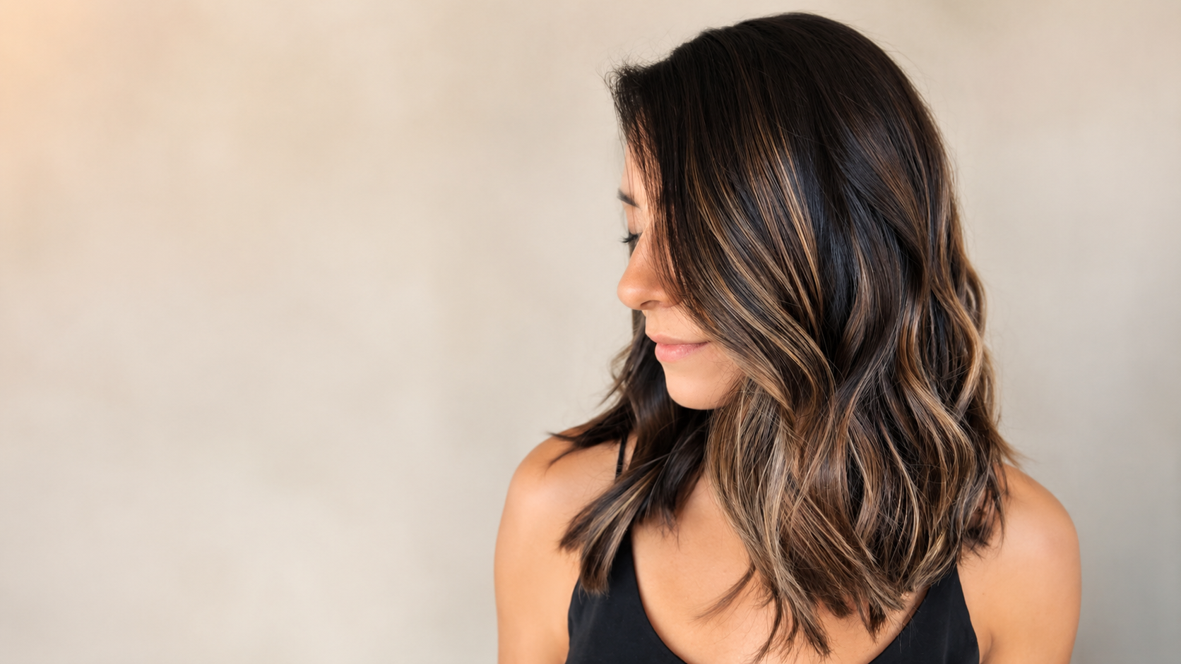 Luxury brunette balayage and seamless hair extensions by The Hair Court Salon & Extension Boutique in Bryan–College Station, Texas.