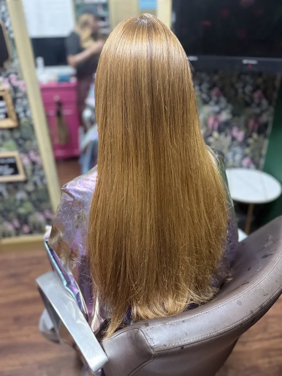 Long golden blonde straight hair by The Hair Court in Bryan-College Station, TX.