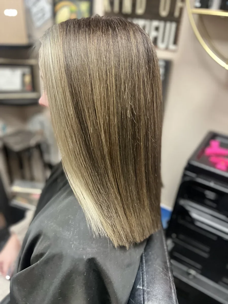 Long dimensional blonde straight hair by The Hair Court in Bryan-College Station, TX.