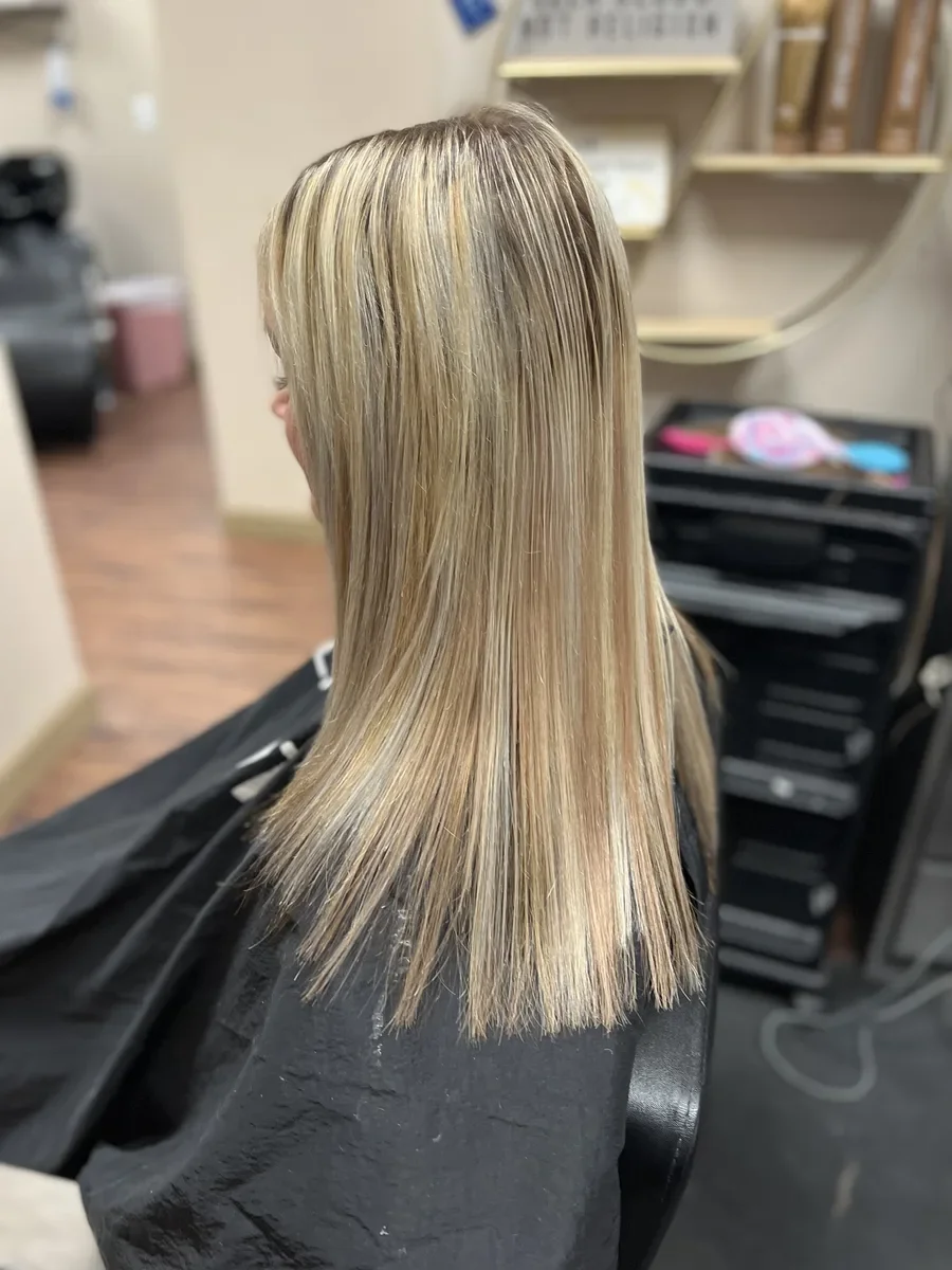 Long blonde straight hair side view by The Hair Court in Bryan-College Station, TX.