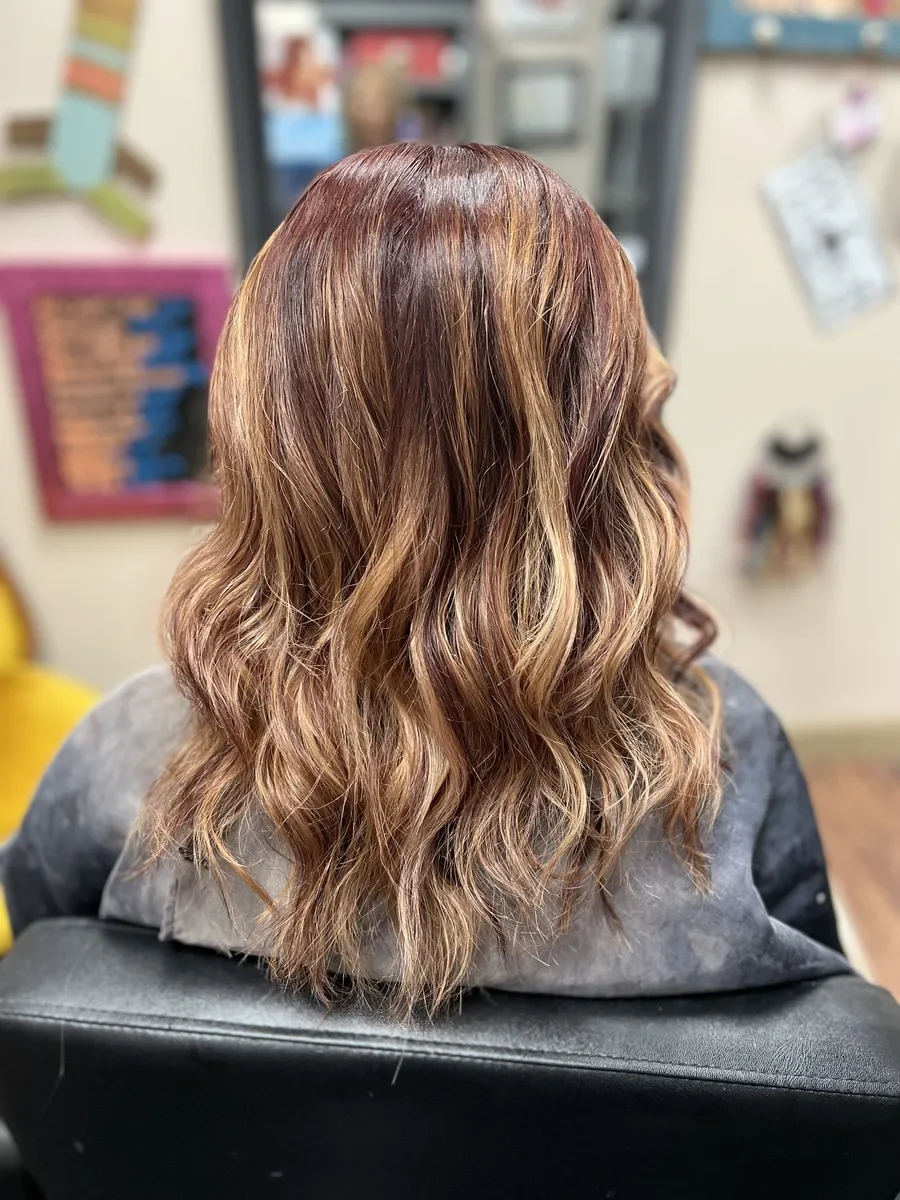 Short copper-brunette wavy hair by The Hair Court in Bryan-College Station, TX.