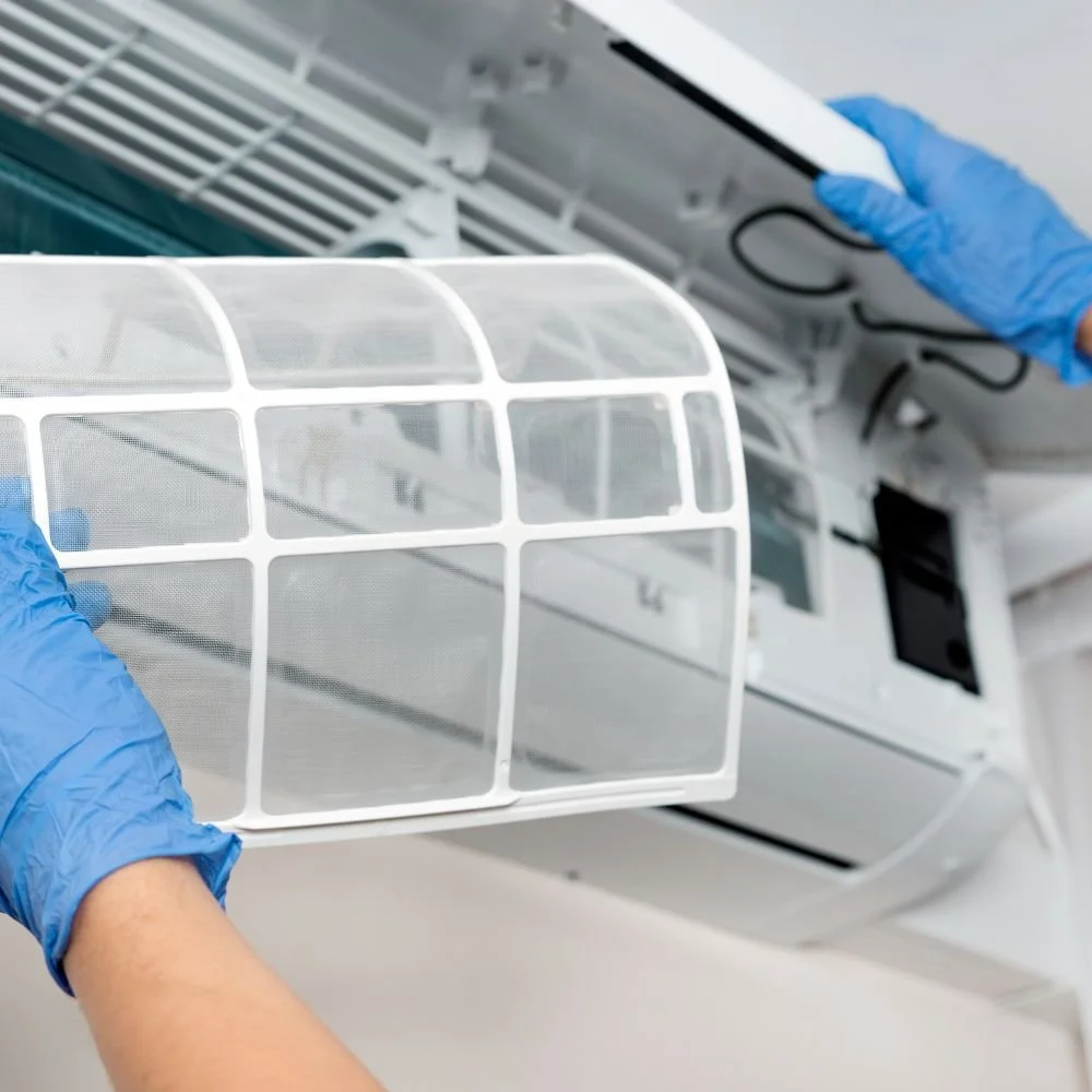 An air conditioning expert installing an air filter from an air conditioning unit at home in Bendigo