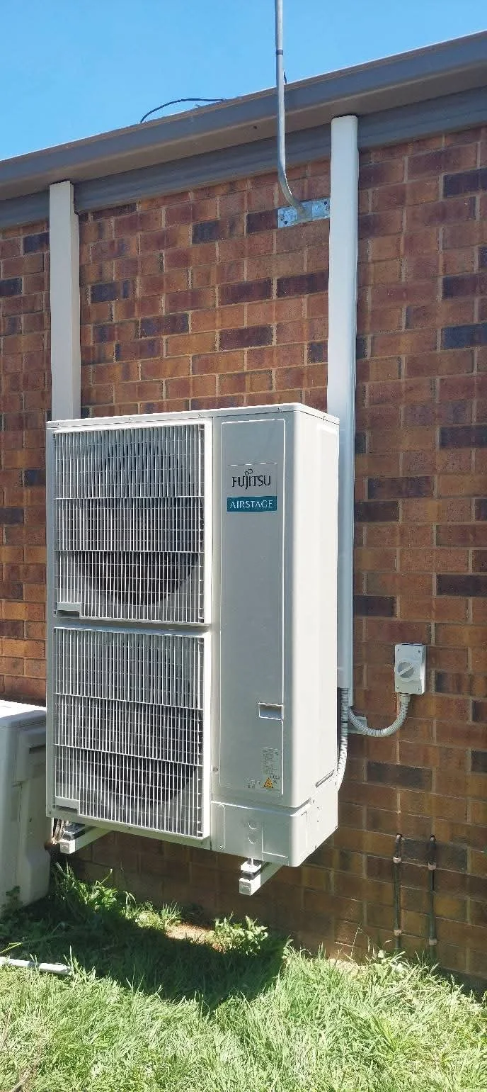 Outdoor Fujitsu air conditioning unit in a home at Bendigo