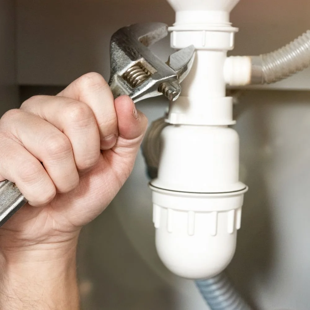 A plumber at Bendigo Plumbing fixing a broken drain pipe