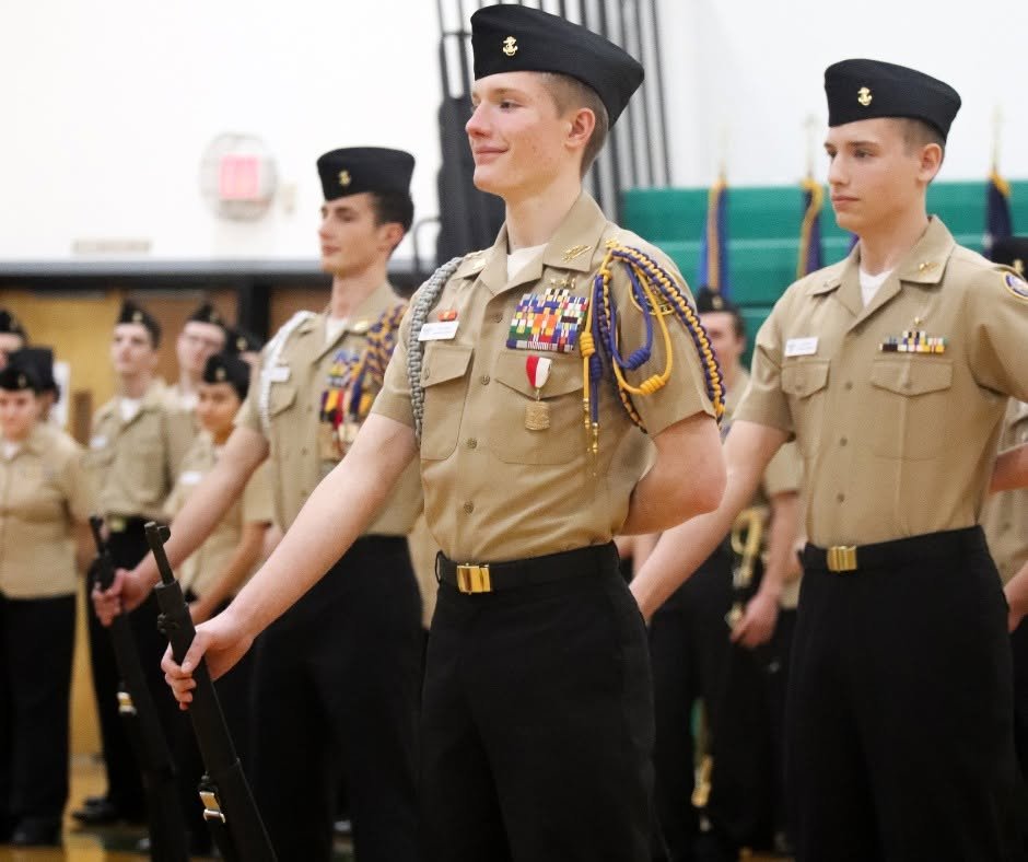 NJROTC Students stand in formation in dress uniform.