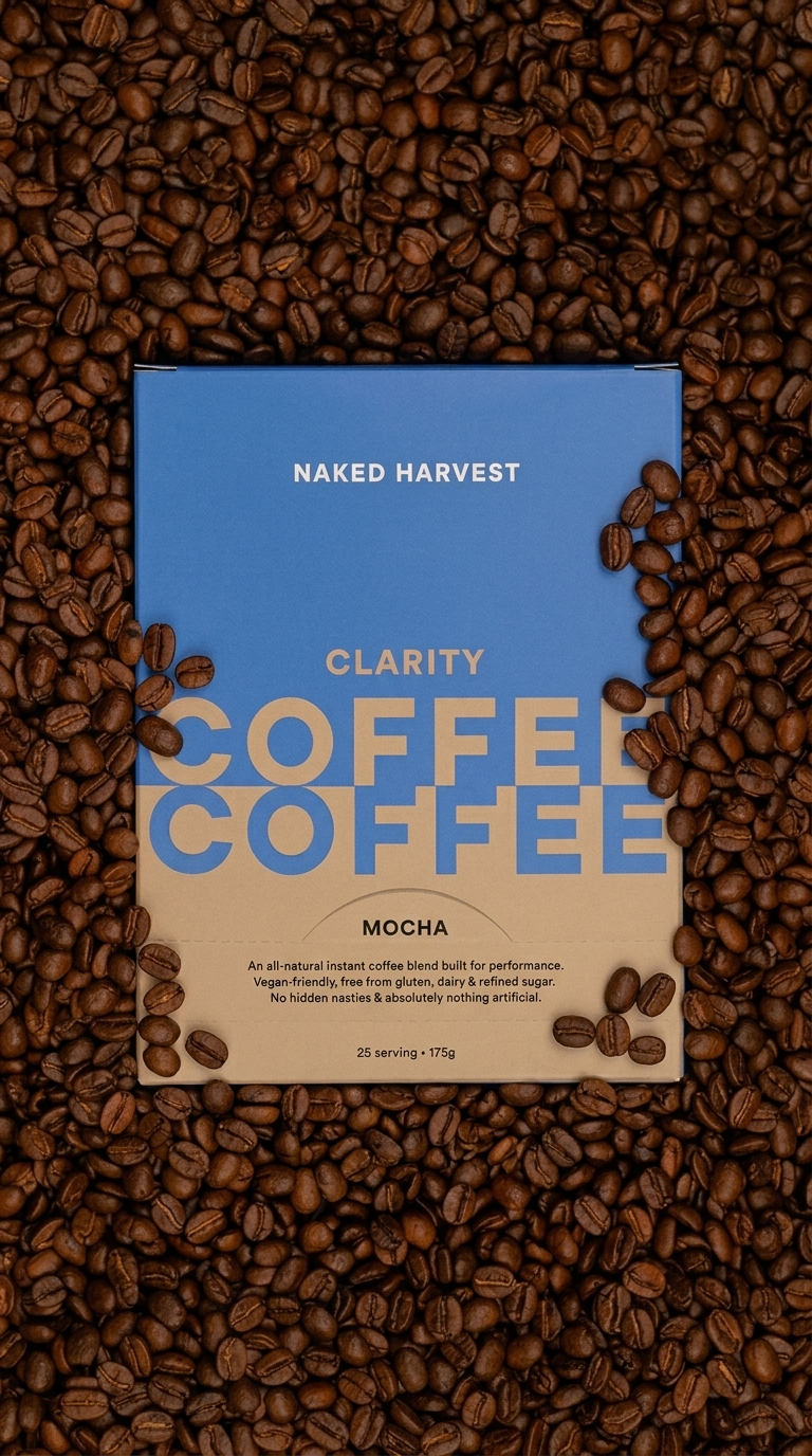 A blue and beige package of Naked Harvest Clarity Coffee Mocha surrounded by roasted coffee beans.