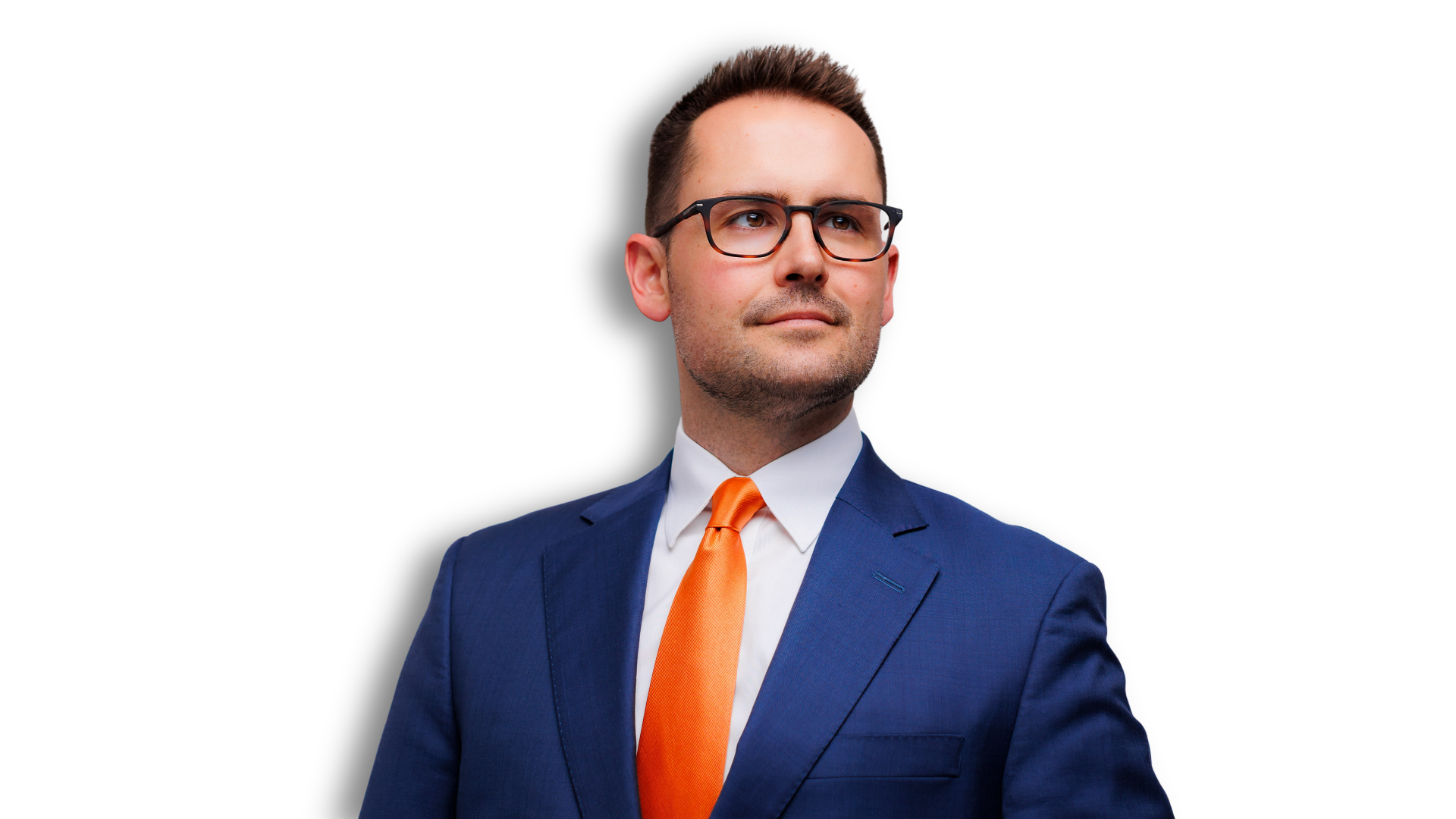 Dr. Tyler King in a blue suit with an orange tie and glasses, looking to his right, against a dark blue background.