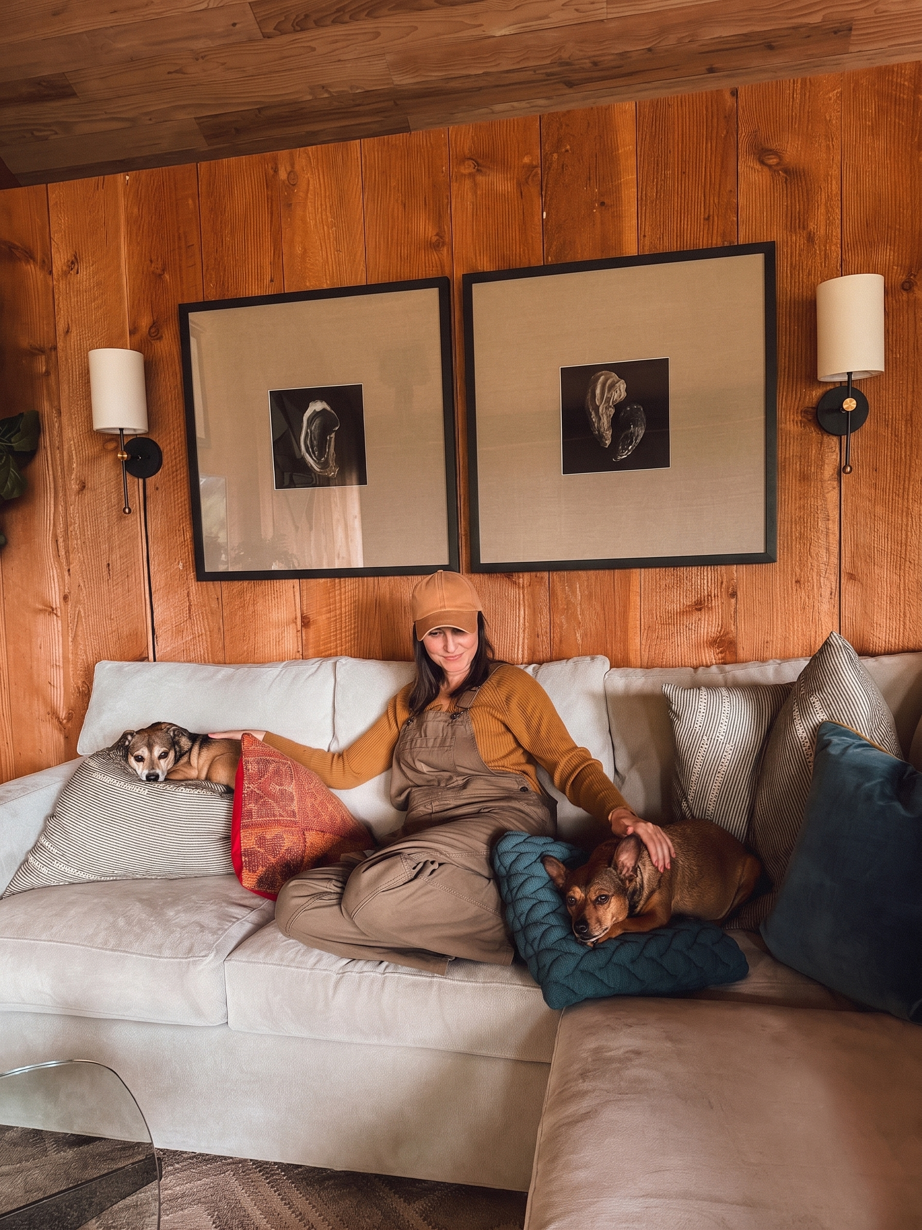Field & Fern founder, Jill, sitting with two dogs in a PNW cabin.