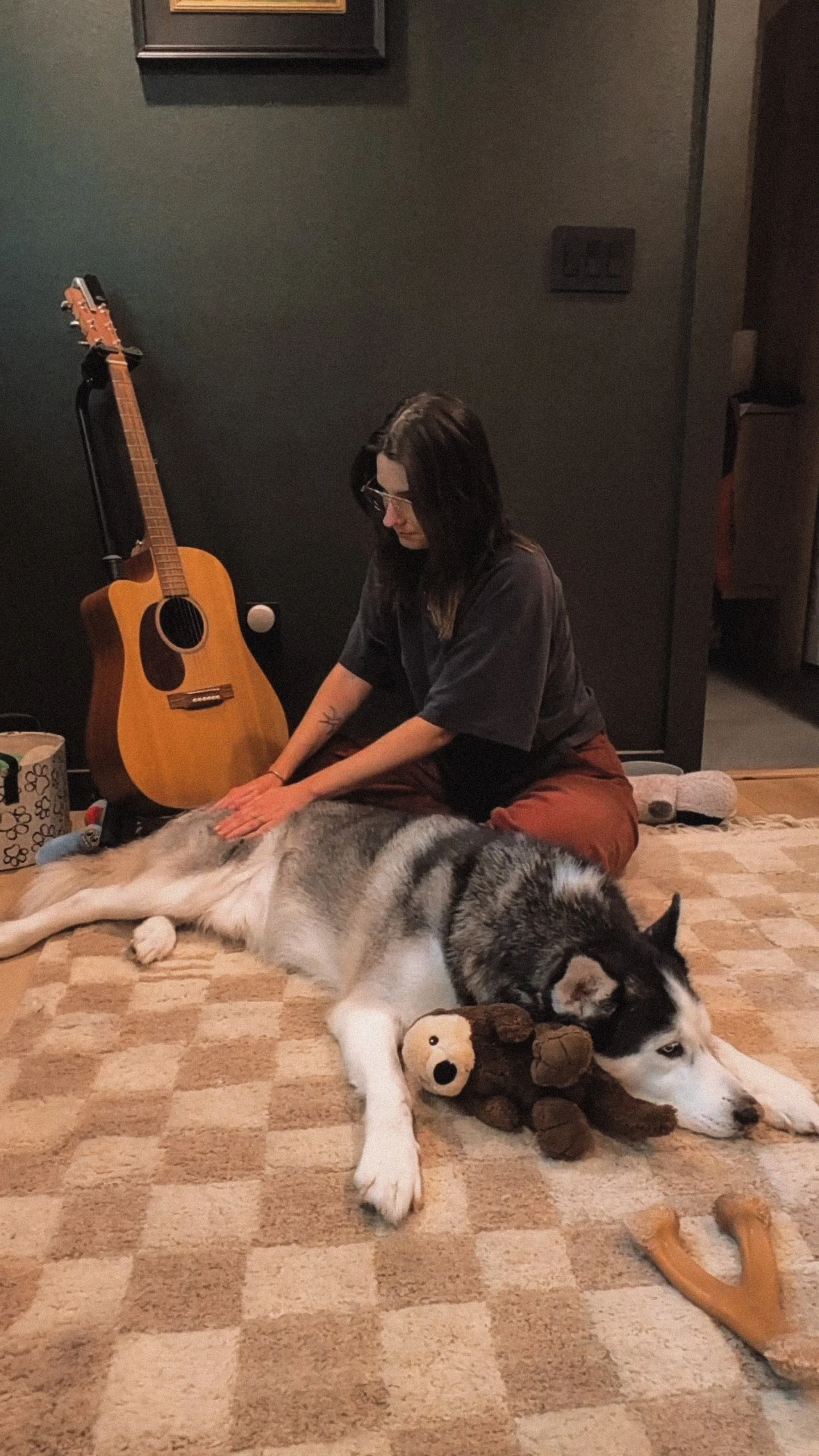 Jill gently massaging her dog Carmy