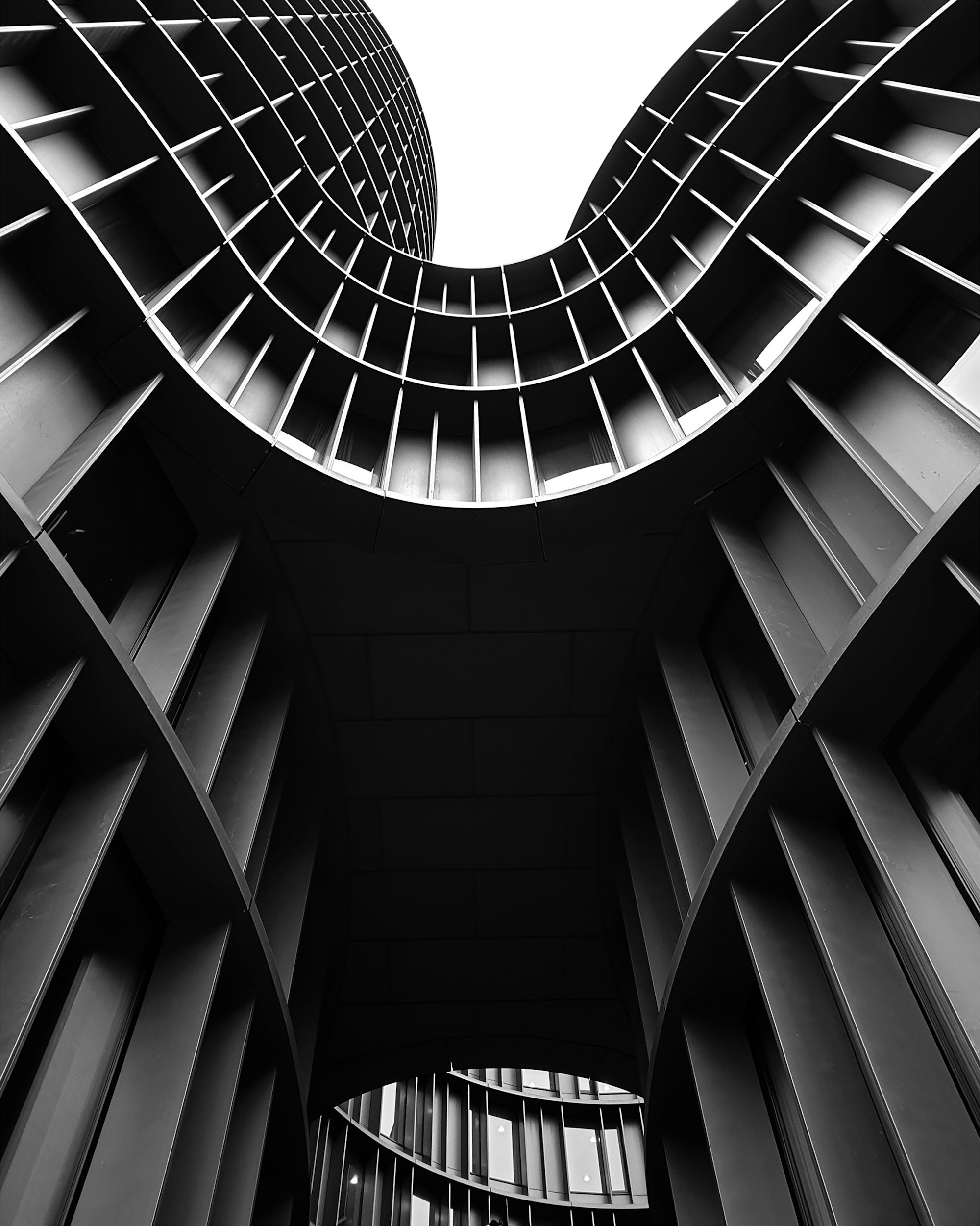 Modern architectural building viewed from below, representing structure, perspective and strategic thinking.