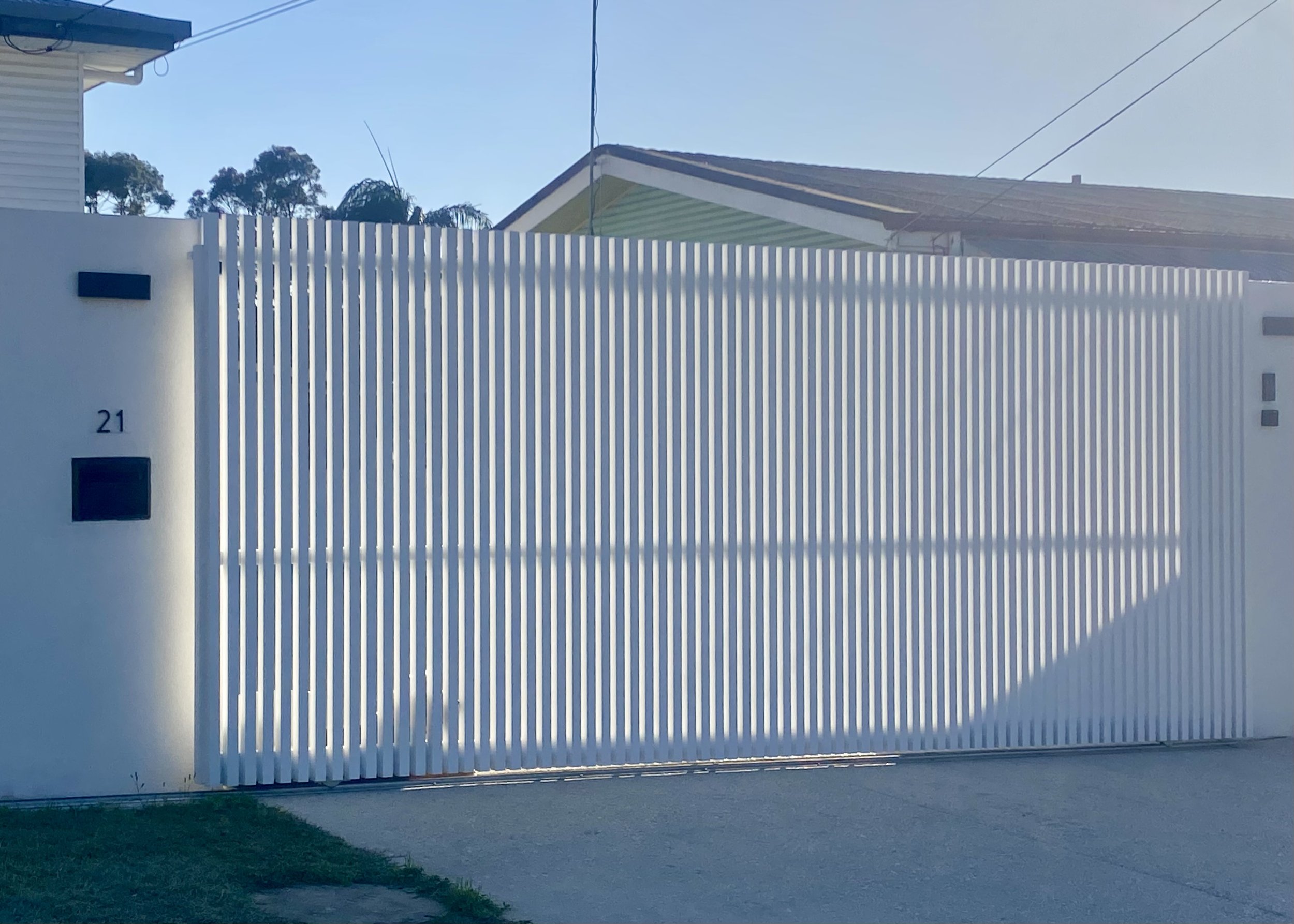 White batten front gate - manufactured and installed by Swift Powdercoating & Fencing Brisbane