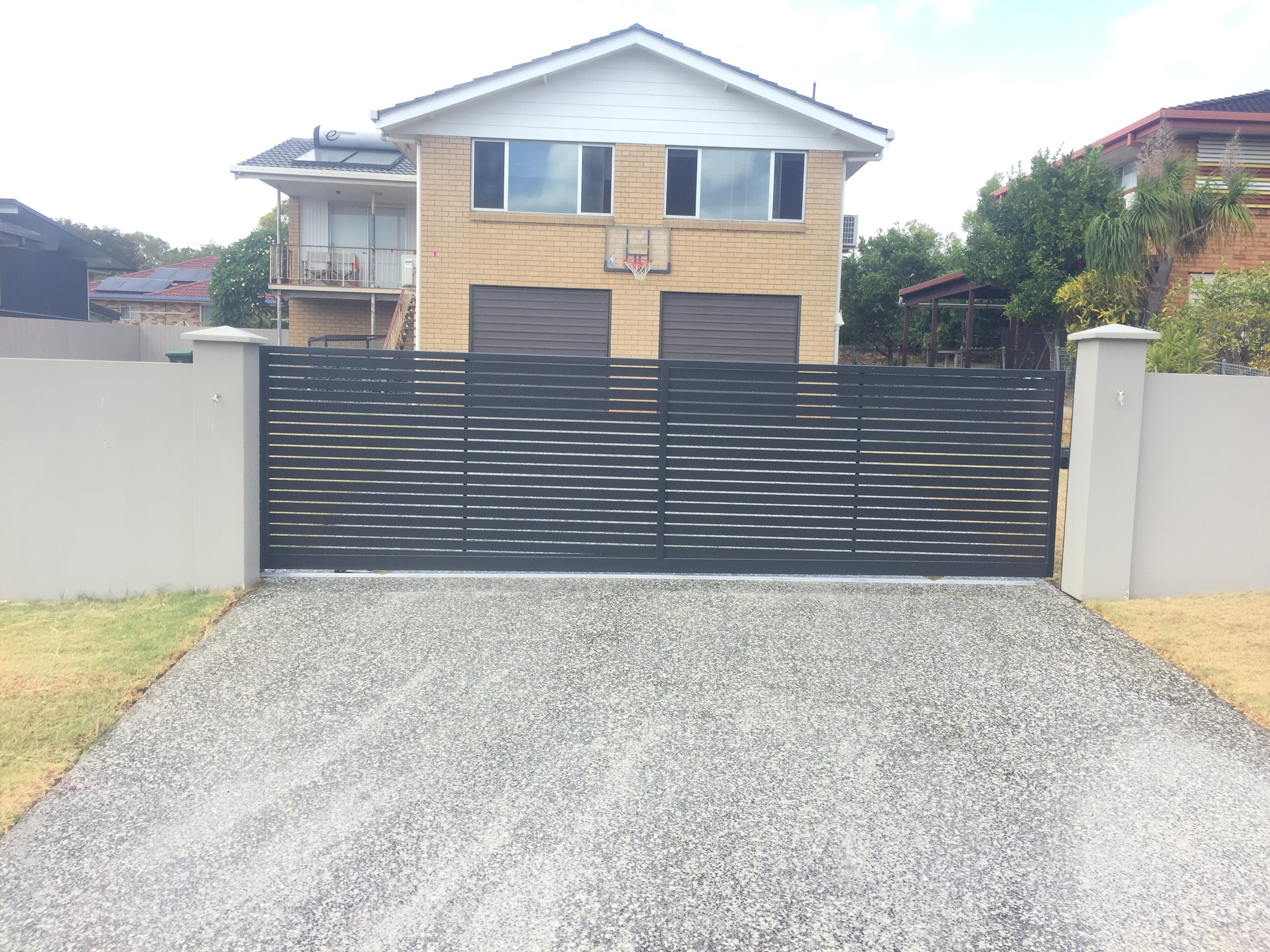 Woodland grey front gate - manufactured and installed by Swift Powdercoating & Fencing Brisbane