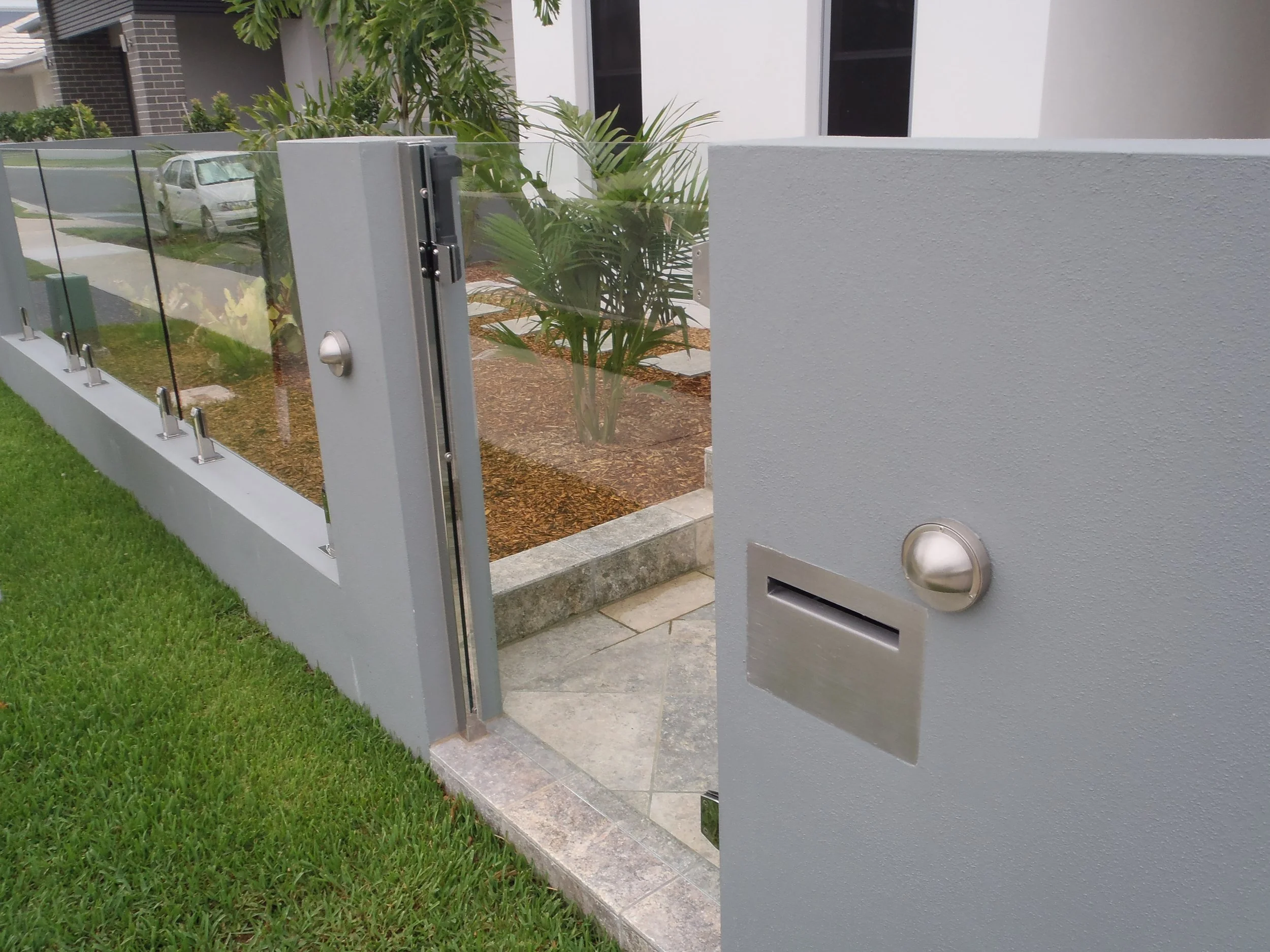 Glass paedestrian gate  manufactured and installed by Swift Powdercoating & Fencing Brisbane